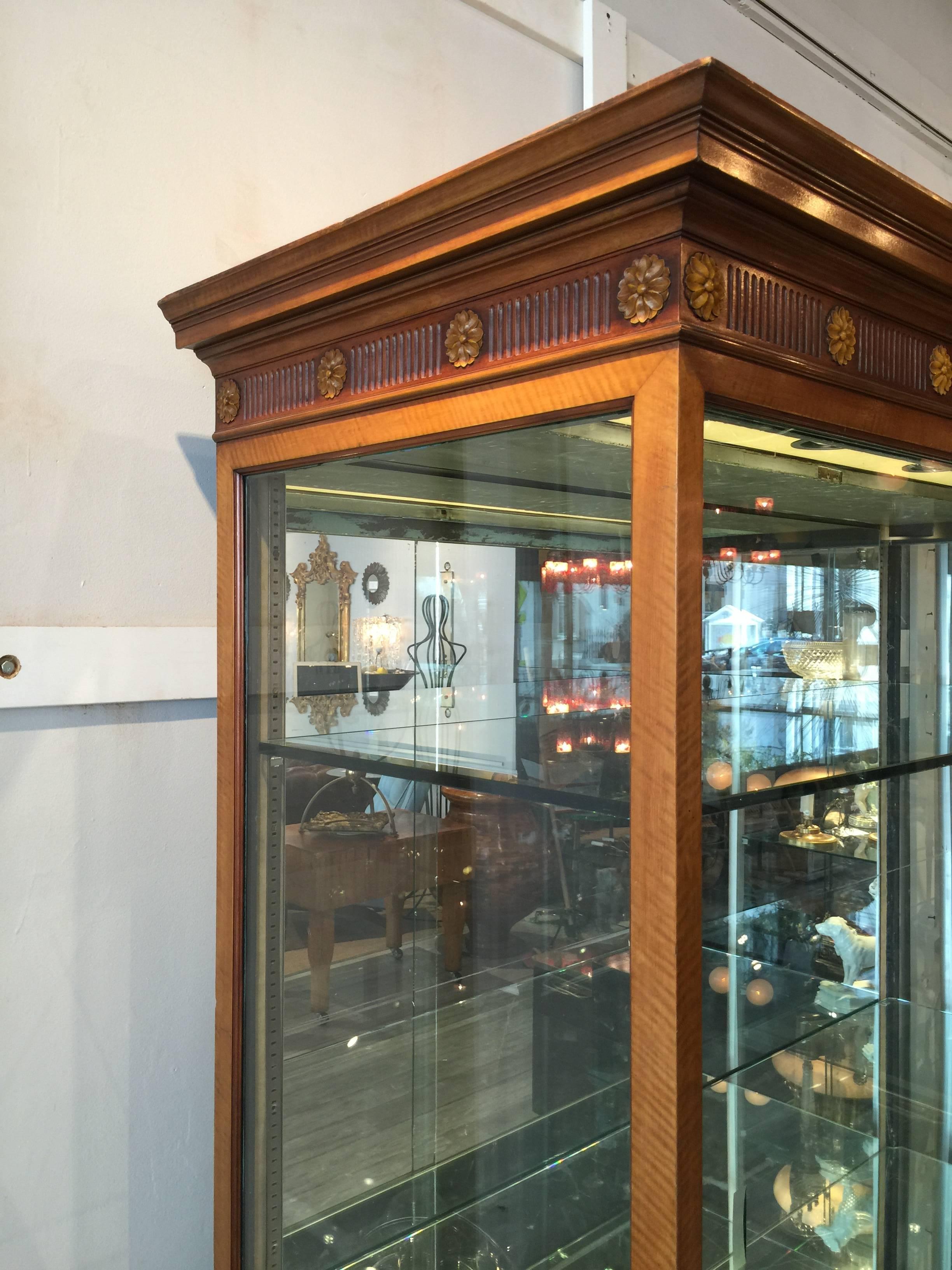 Edwardian Satinwood Display Cabinet
From J.E. Caldwell Jewelry, Philadelphia
The beautiful refined carved case with two sliding glass doors with two glass shelves, mirrored and lighted interior, raised on finely carved reeded legs.
Made in two