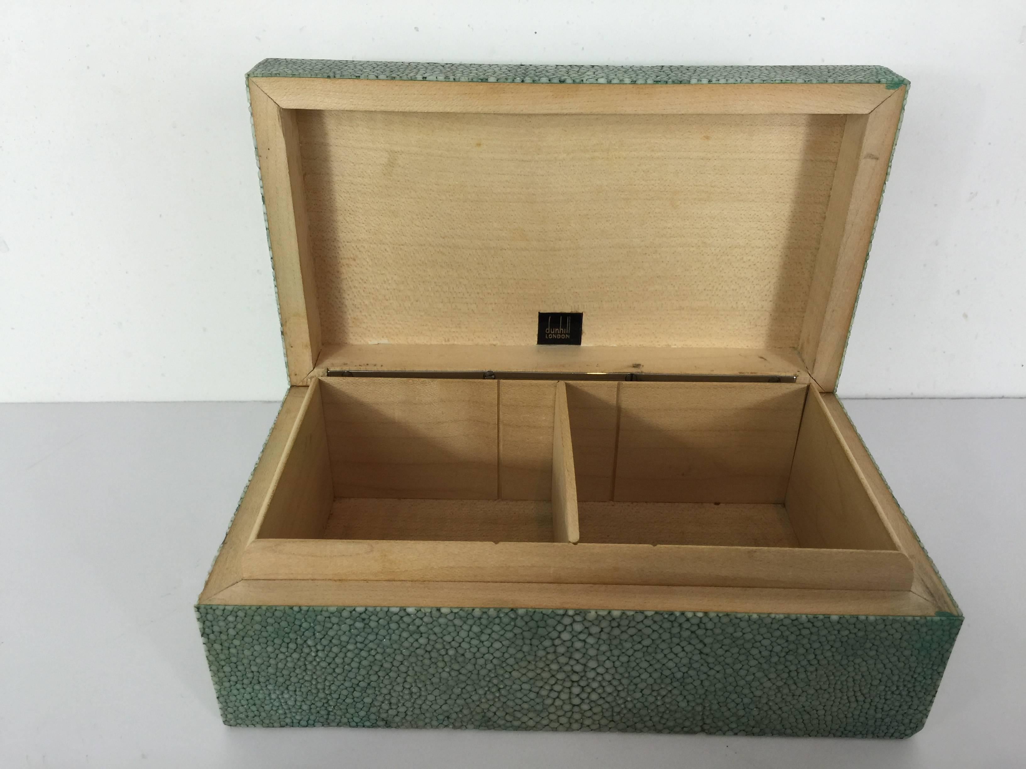 Art Deco Dunhill Shagreen table box, of rectangular form with bookmatched green and white Shagreen with adjustable divided wooden interior. Signed on the interior of the lid "Dunhill, London". The interior measures 6" wide x 3"