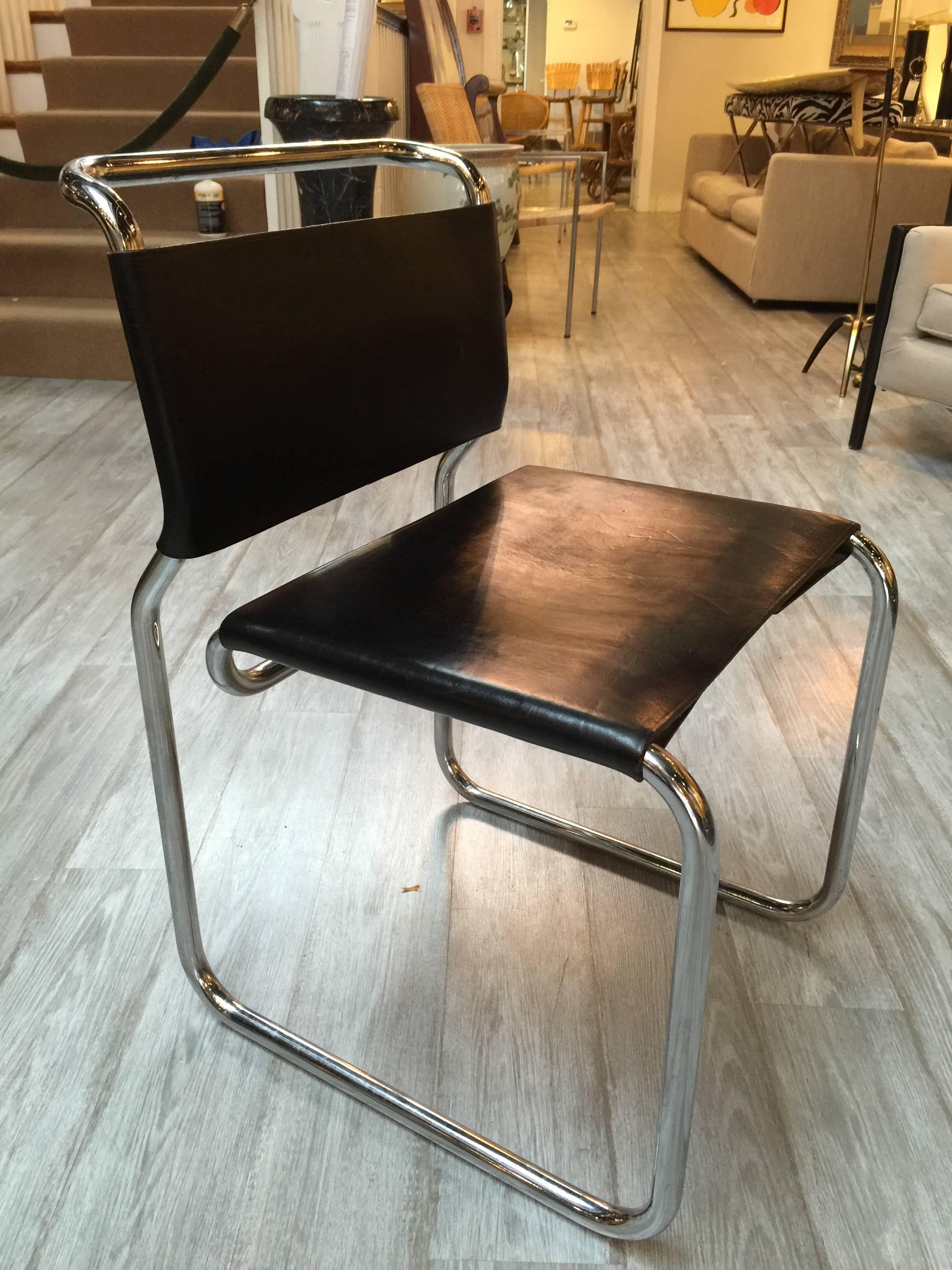 Set of ten Nicos Zographos leather and chrome chairs, each one of heavy construction and original black leather spring and gamut construction sling backrest and seats, original condition, some signs of wear on some of the leather seats all sturdy,