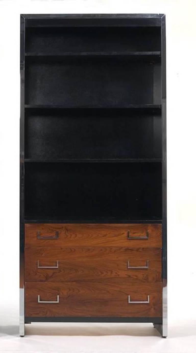 Milo Baughman rosewood bookcase, with chrome surround and hardware, the upper case fitted with three shelves. The lower case with three beautifully figured long drawers. Measures: 84 ½" x 38" x 15".
 