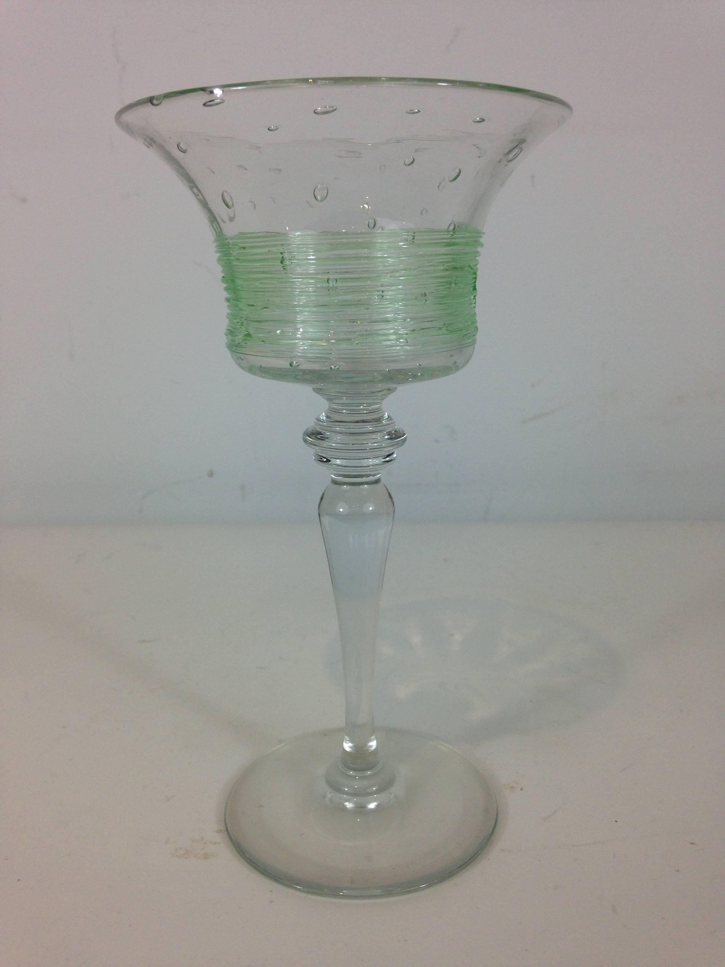 12 Art Deco goblets, each one handblown with the upper part with controlled bubbles and green threaded glass, raised on a tapering shaped stem with circular base.