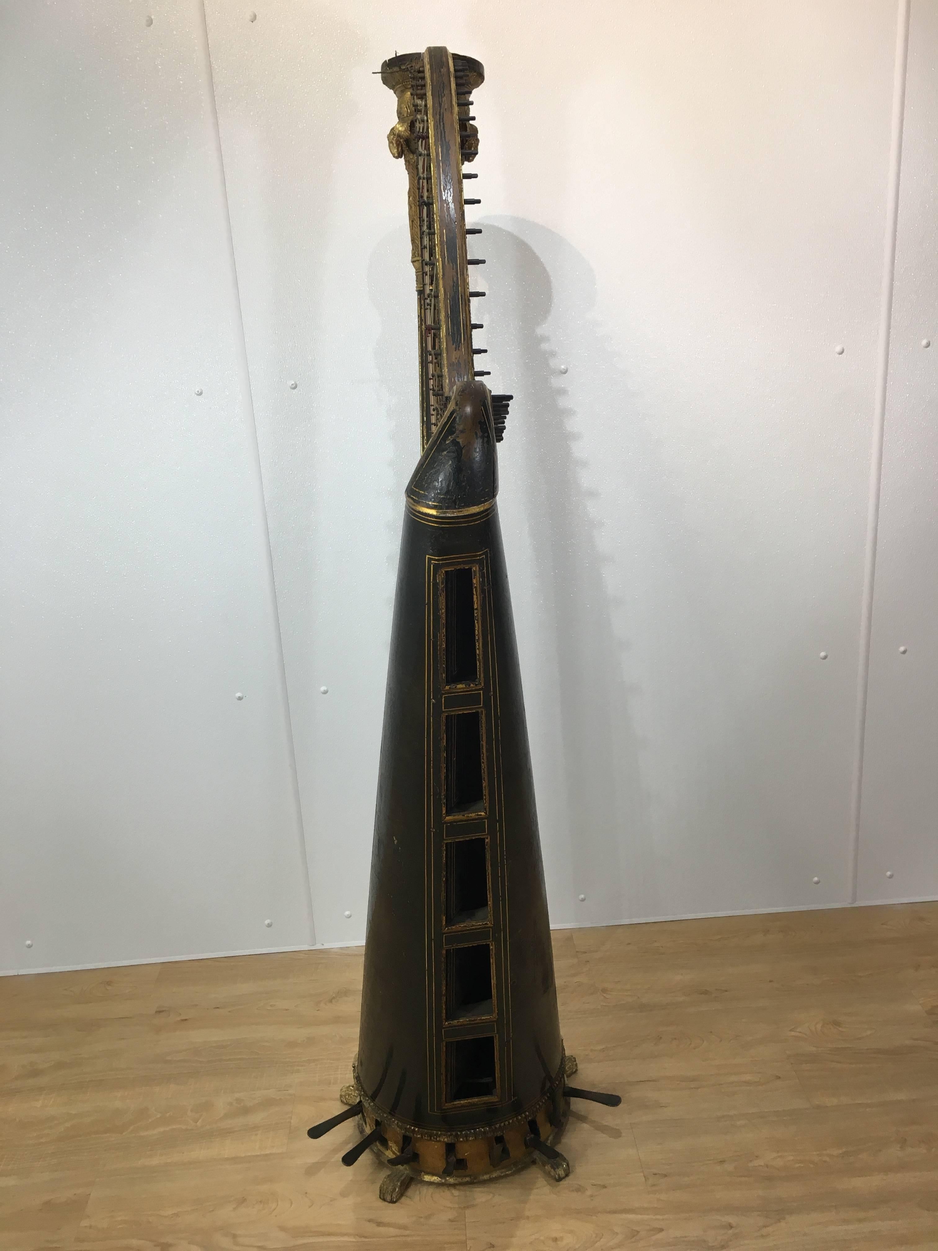 Antique Sebastian Erard concert harp, of typical form with Ram’s head column and ebonized black and gold finish, in good well cared for antique condition, presets beautifully not operational.