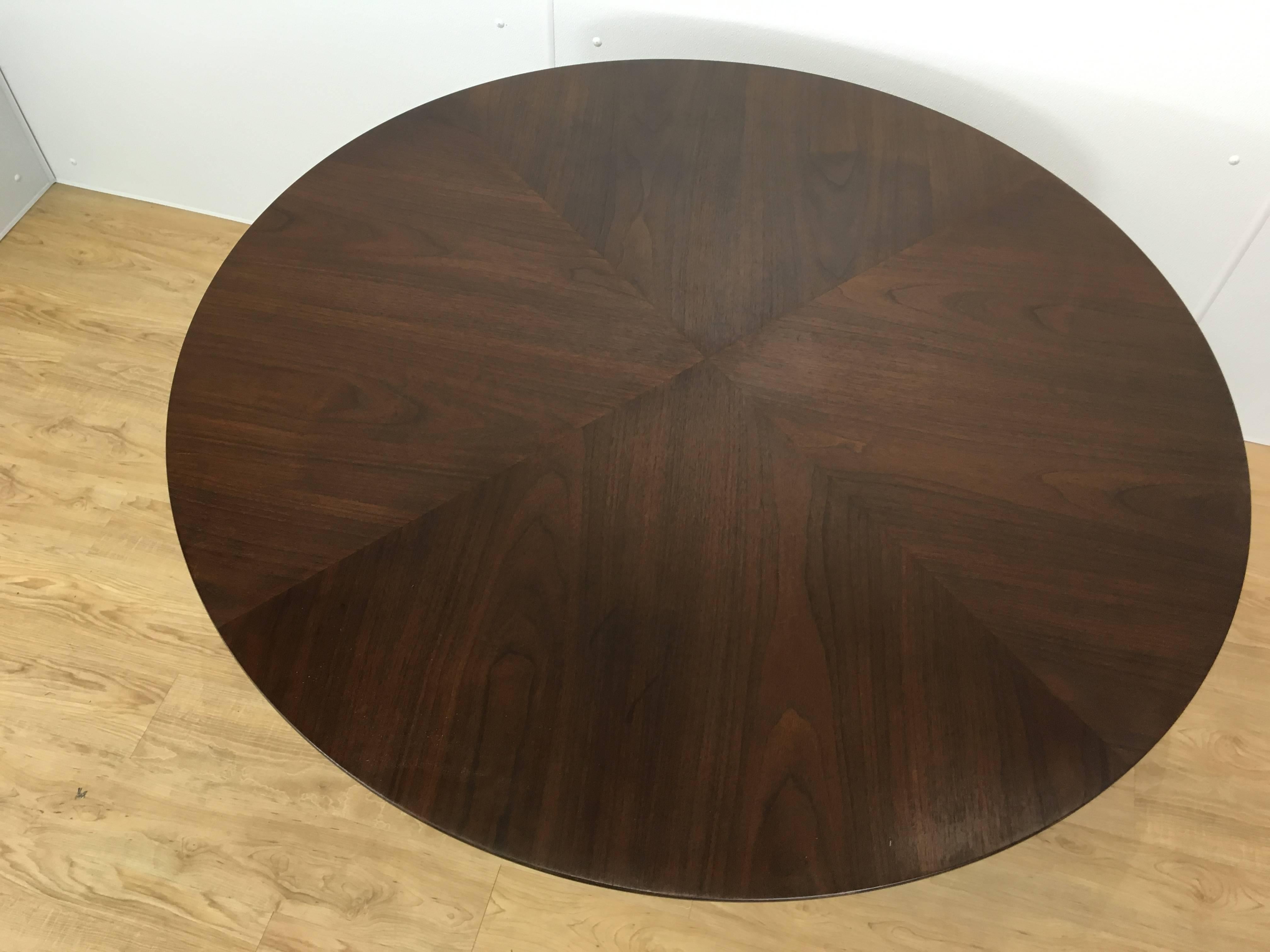 Early KNOLL Tulip Rosewood Dining Table, with beautiful figured bookmatched 48 inch sectioned circular top, on a typical white enameled pedestal base.
