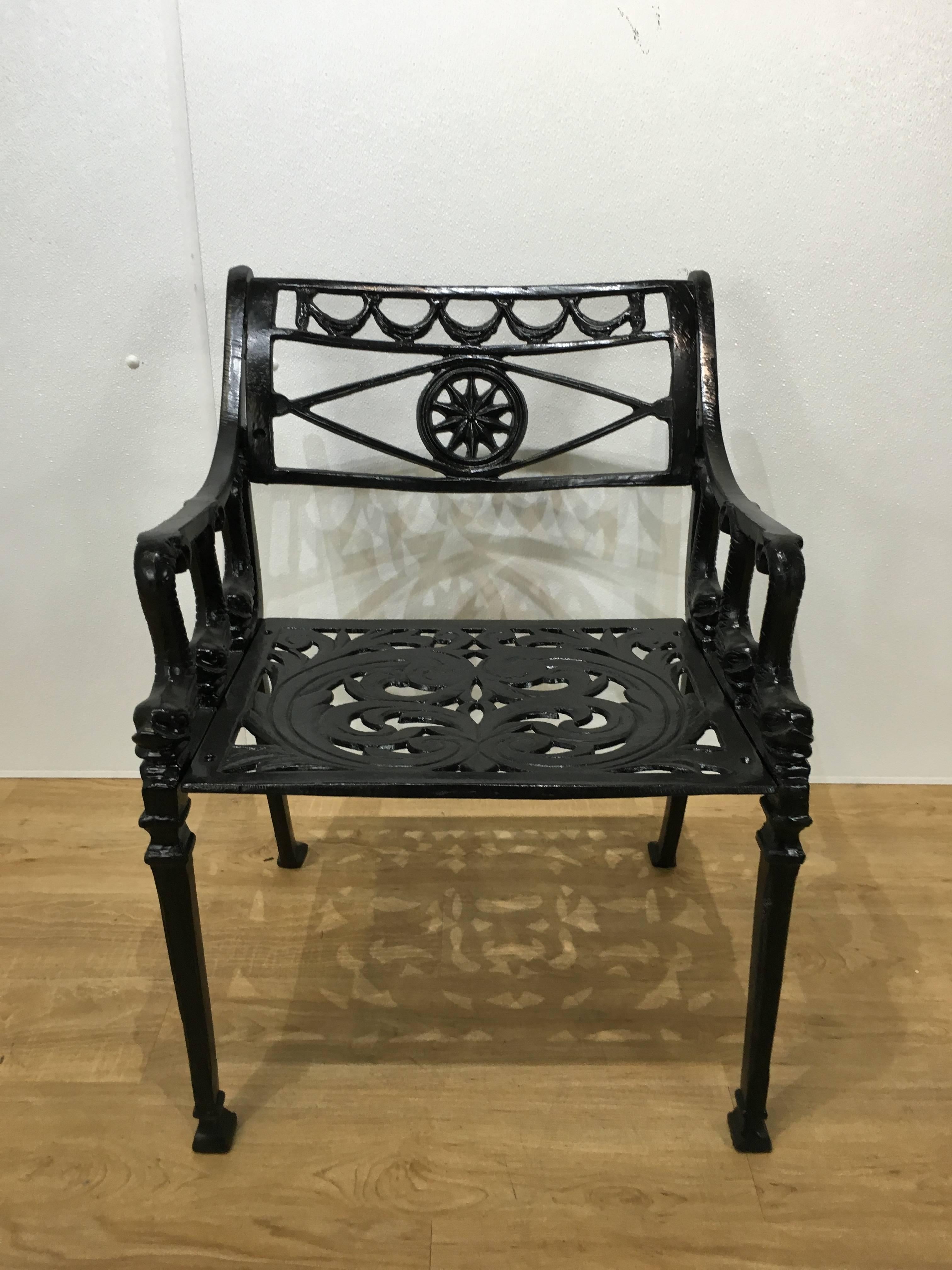 Four molla garden chairs, each with pierced neoclassical backrest and seats with armrests supported by six dolphins. Retains original weathered surface with new enamel paint. 

We have the coordinating dining table, side table, and cocktail table