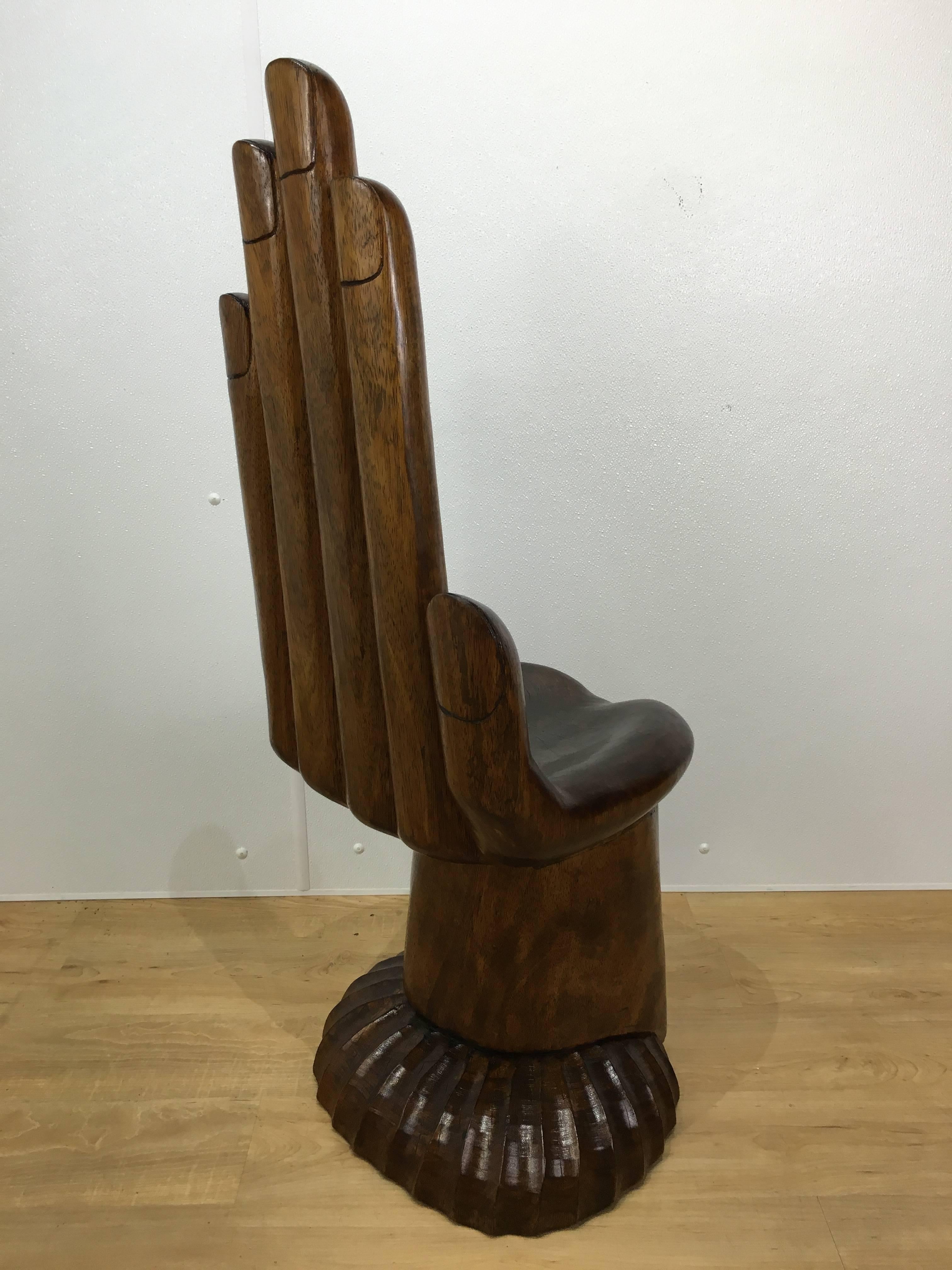 Stunning solid carved mahogany hand chair in the style of Pedro Friedeberg. Rich finish shows the wonderful variations and details in the wood. Unmarked.