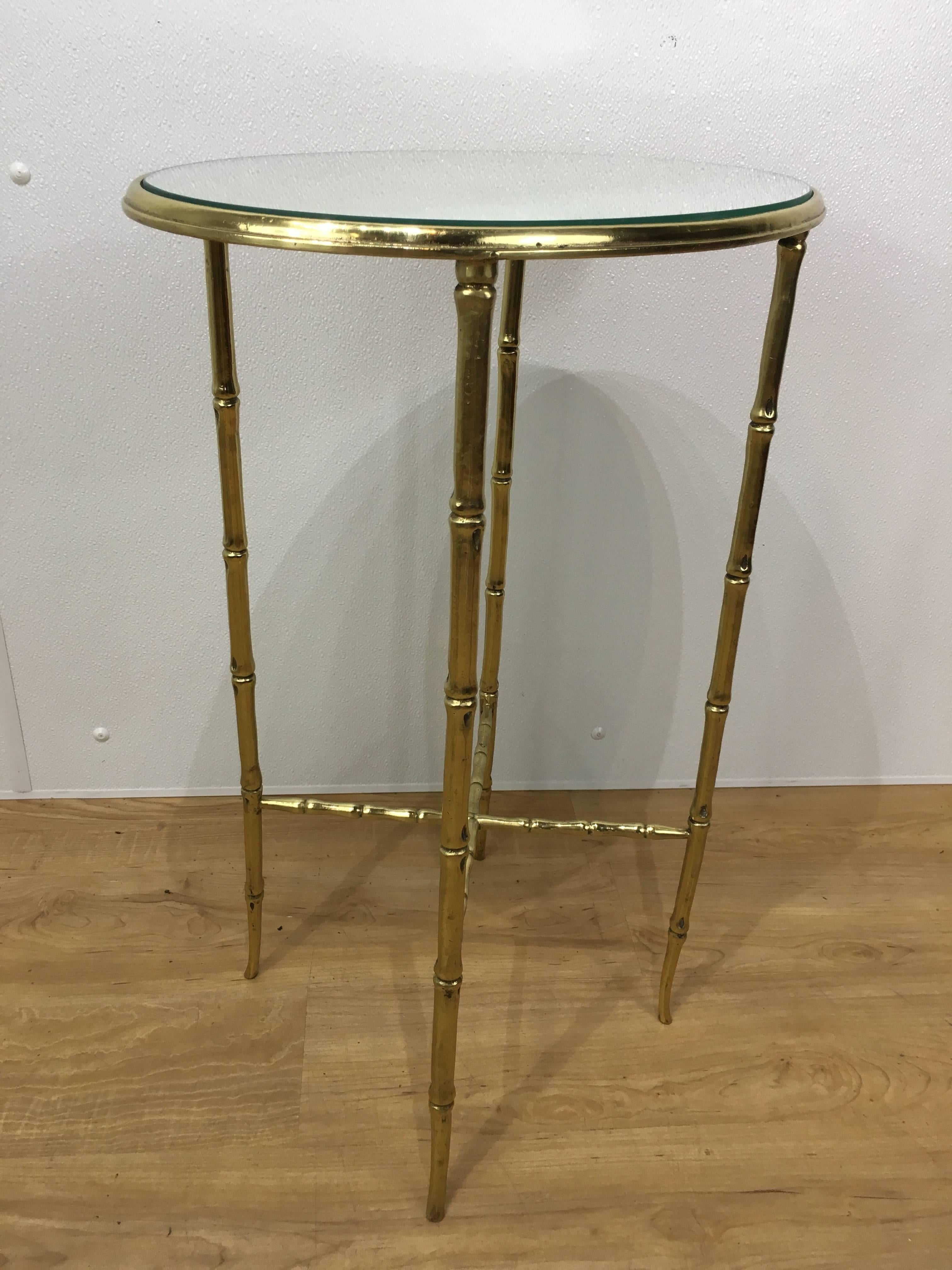Elegant bamboo motif brass side table, finely cast with oval mirror top on conforming bamboo motif base.