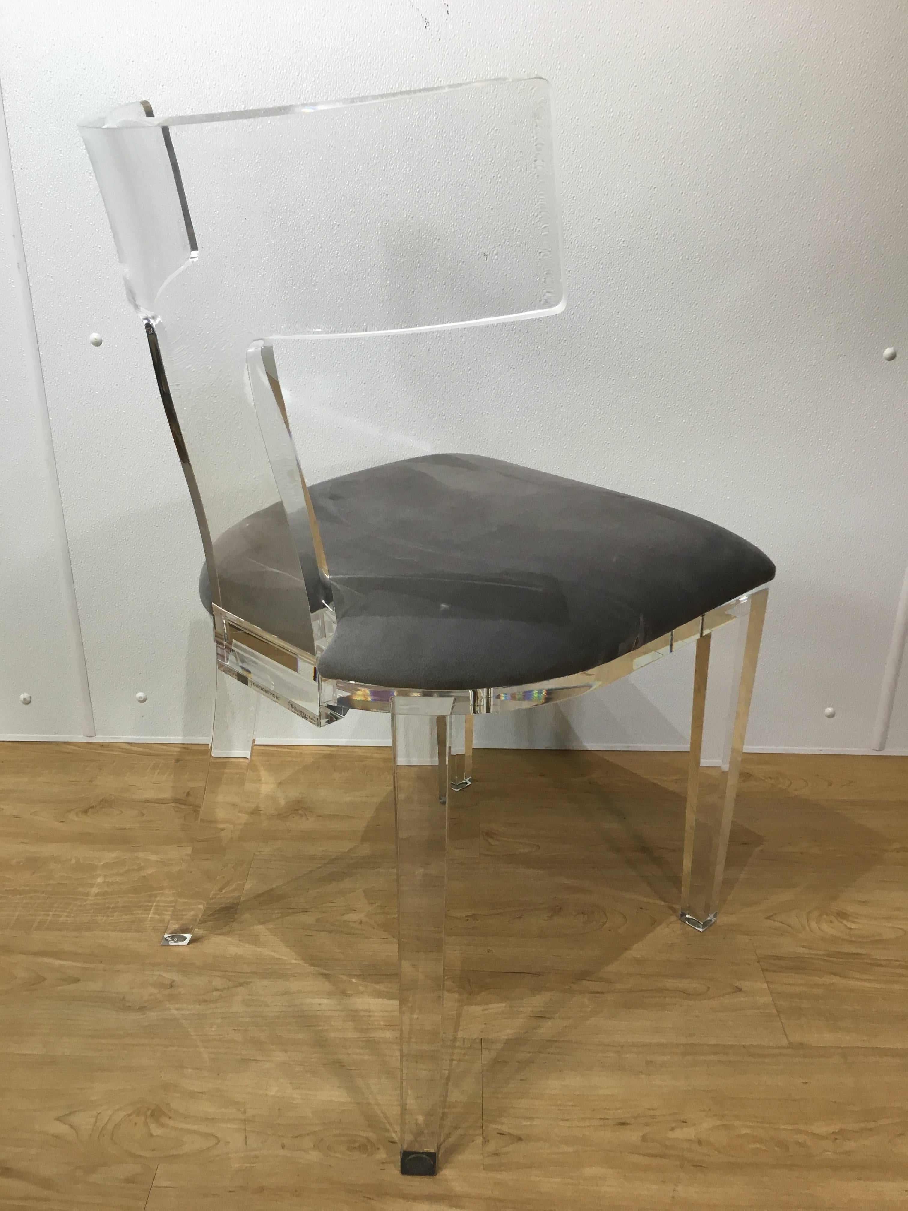 A single Lucite "T" back chair made of one solid piece of Lucite. Very heavy construction.