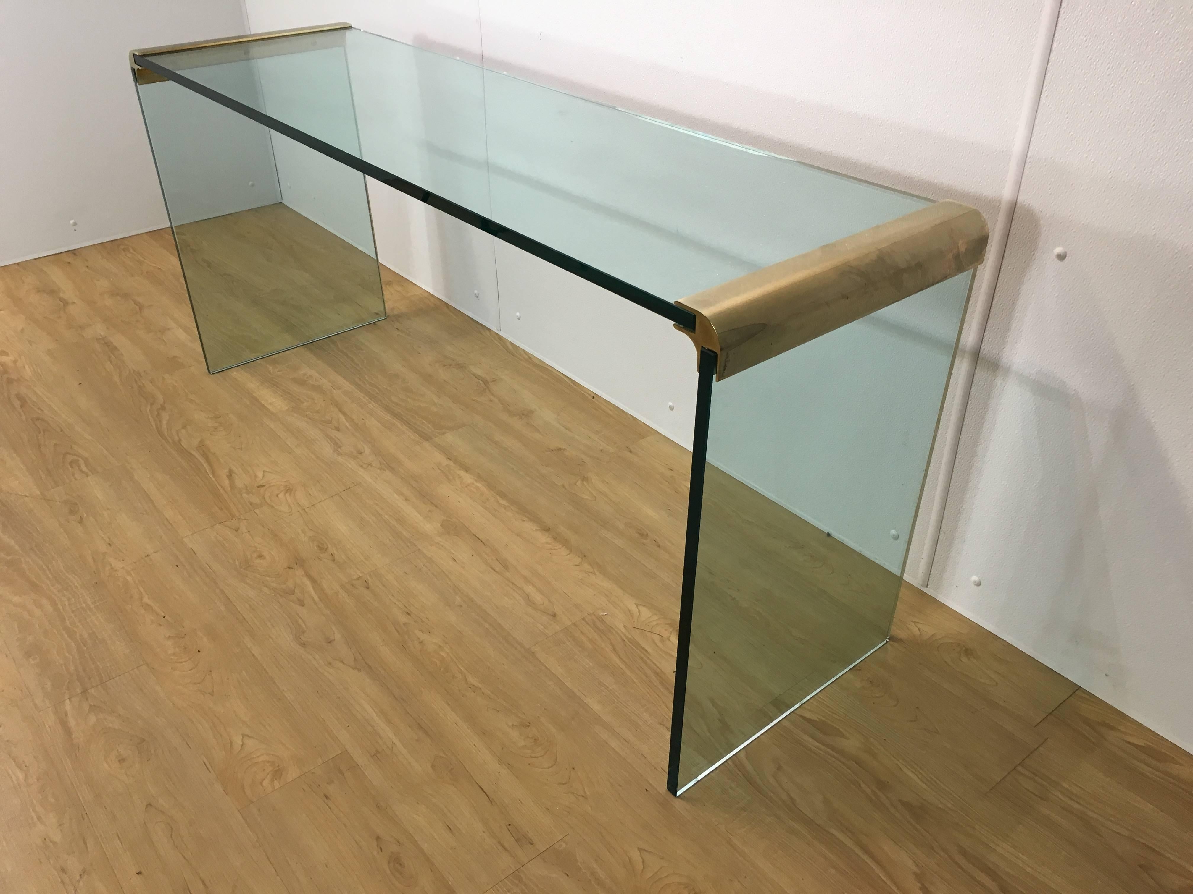 Large Pace Collection glass and brass console table. Thick glass legs and top connected by solid brass connectors.