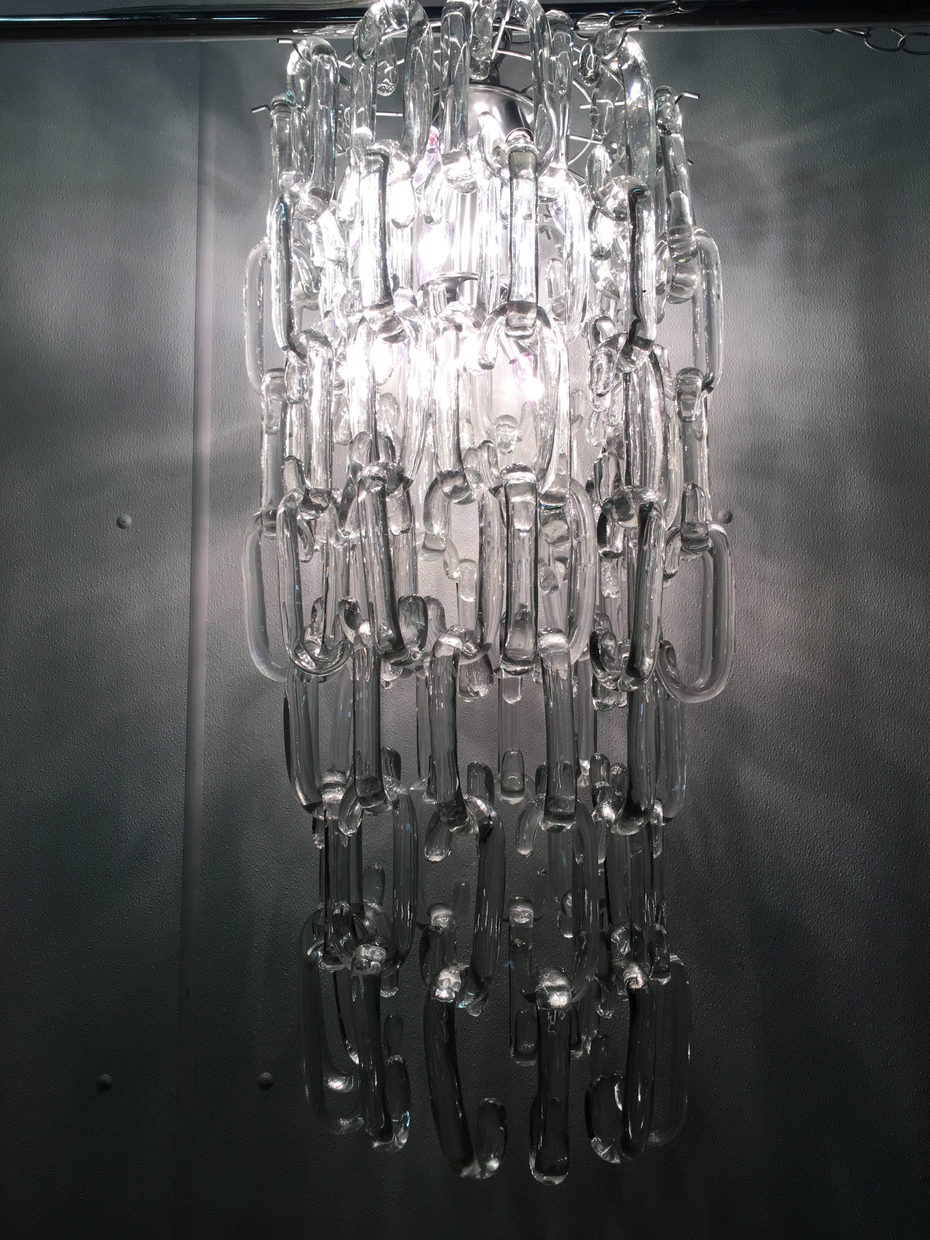 Fabulous cascading Murano glass link chandelier. Chandelier can be adjusted by removing links and to fit a specific space. Each link measures 6" H. As shown the chandelier measures 35" H x 15.25" W. Ten light sockets.U