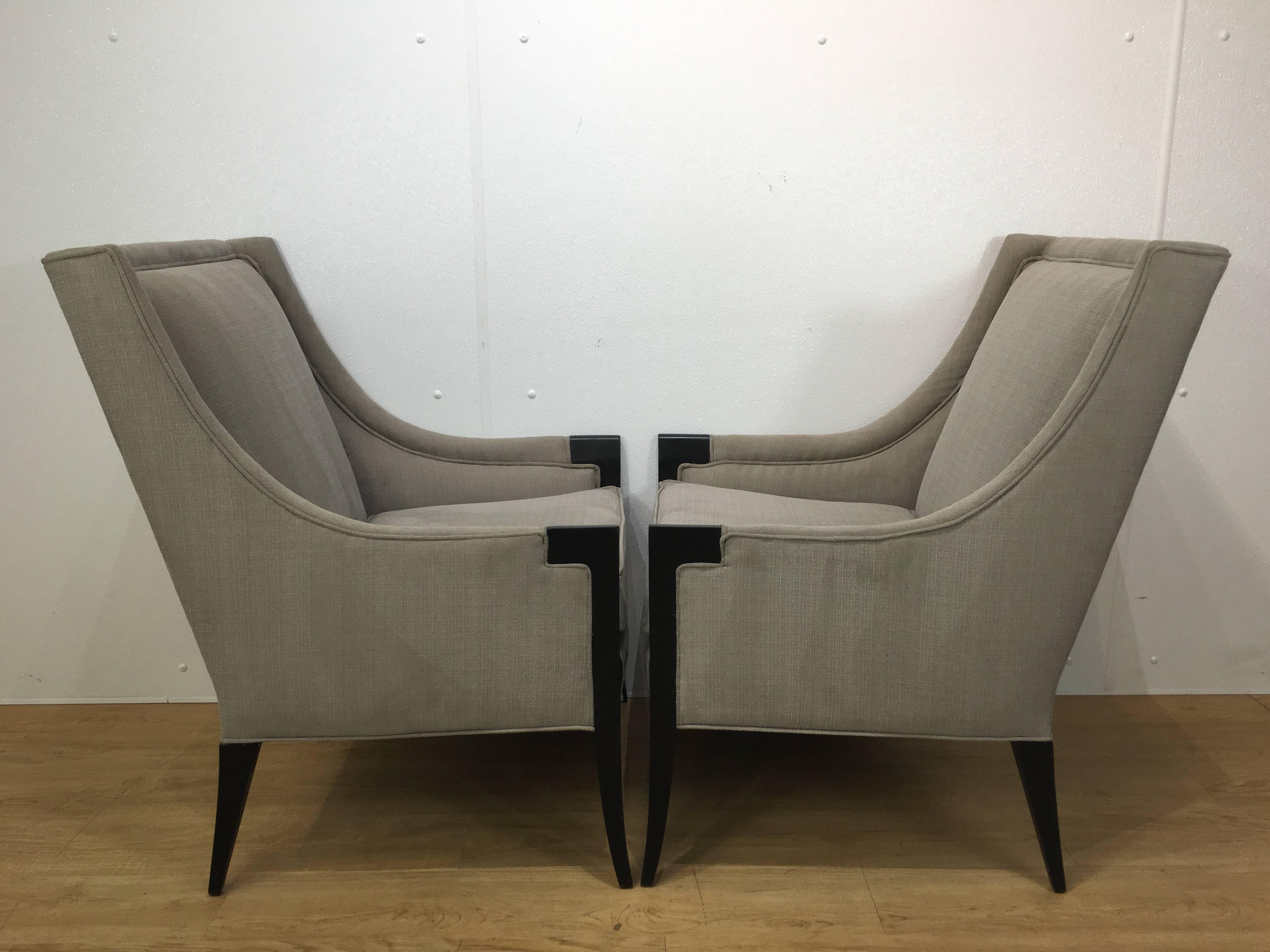 A pair of attributed Edward Wormley for Dunbar chairs newly upholstered in neutral grey fabric with ebonized frames.