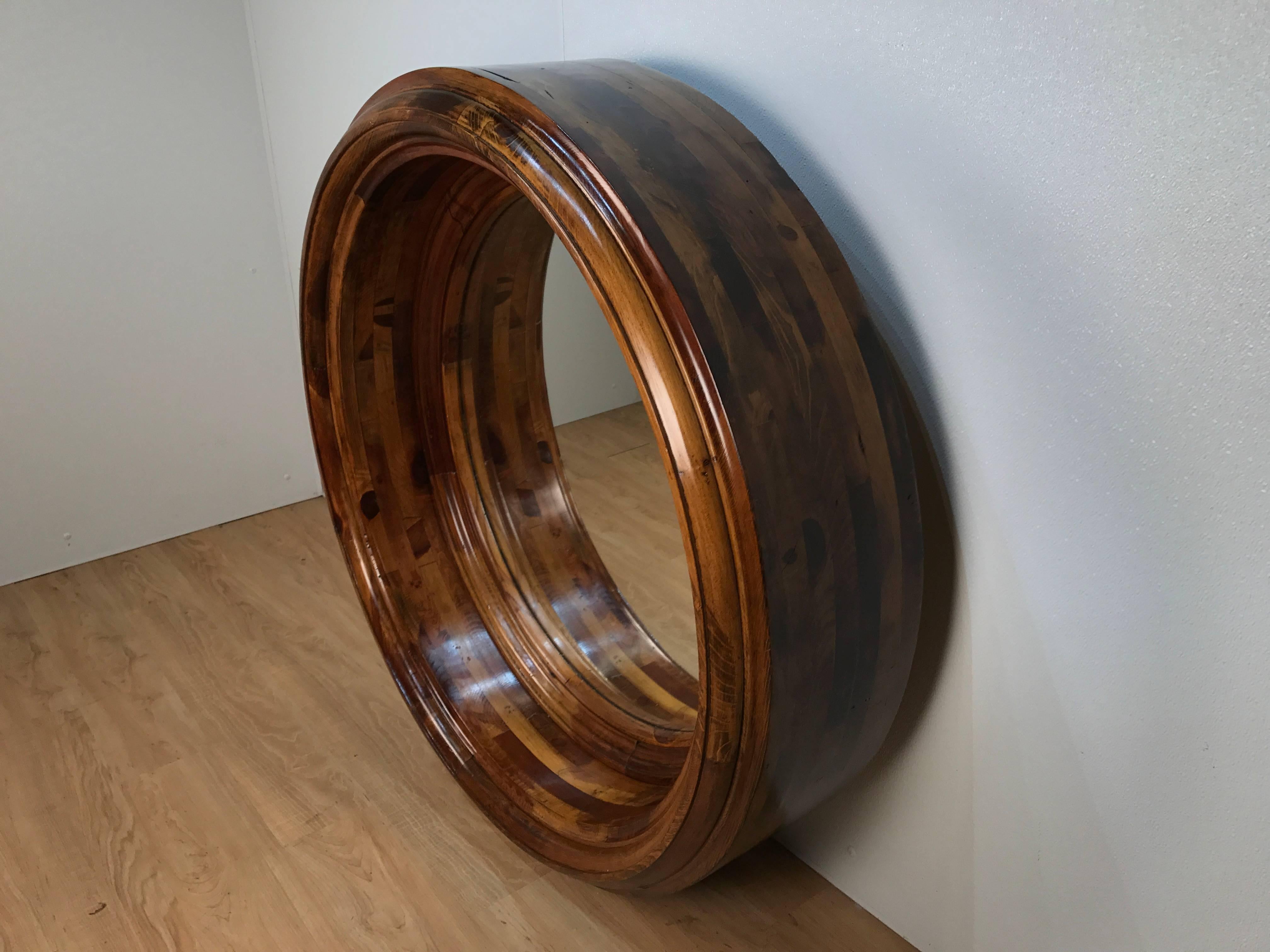 Massive circular porthole mirror, deep with continuous inlaid wood strips in the Treen tradition.