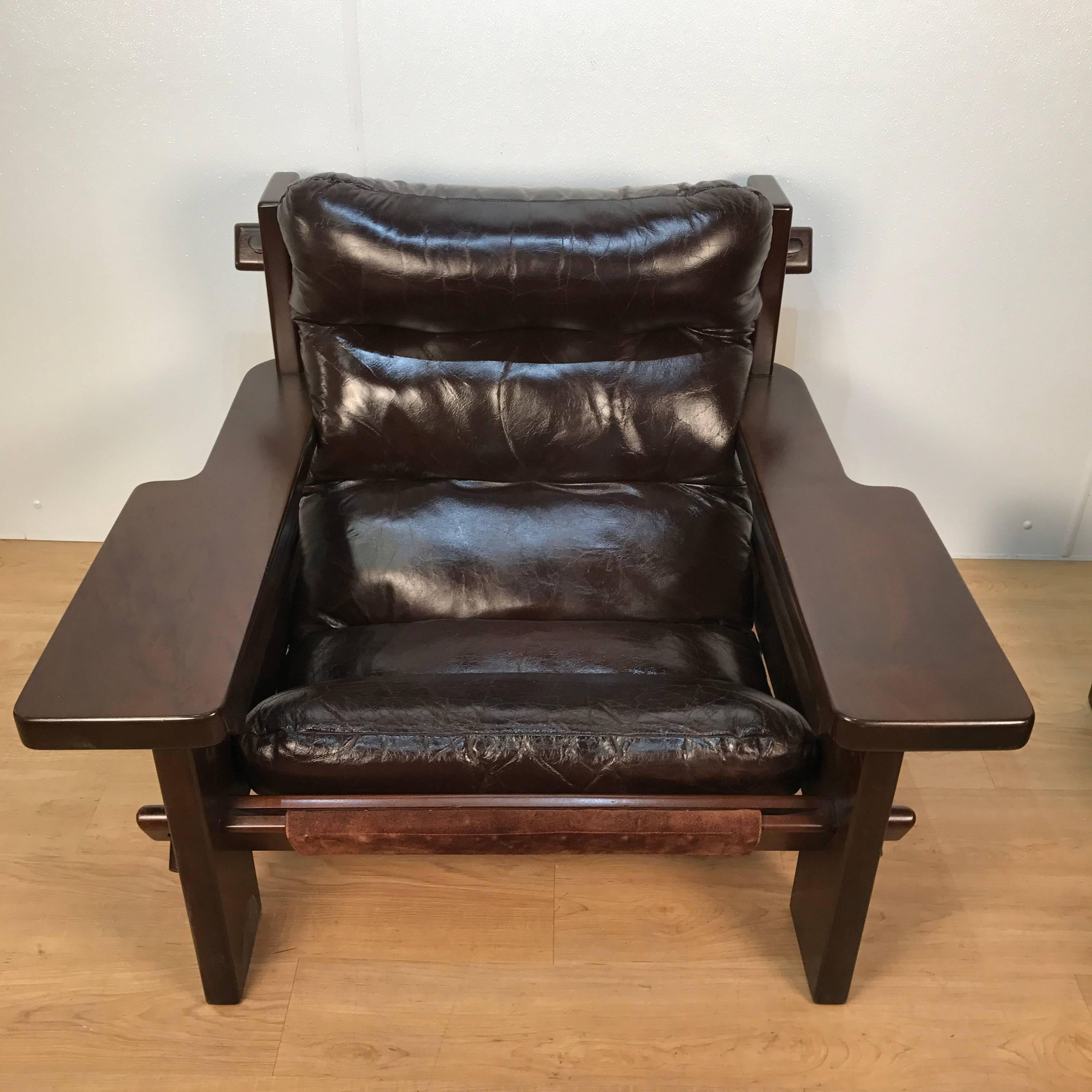 Large-scale Jean Gillon chair and ottoman, a masterwork with pegged construction, in original untouched condition, showing distress on the leather
The ottoman measures 30