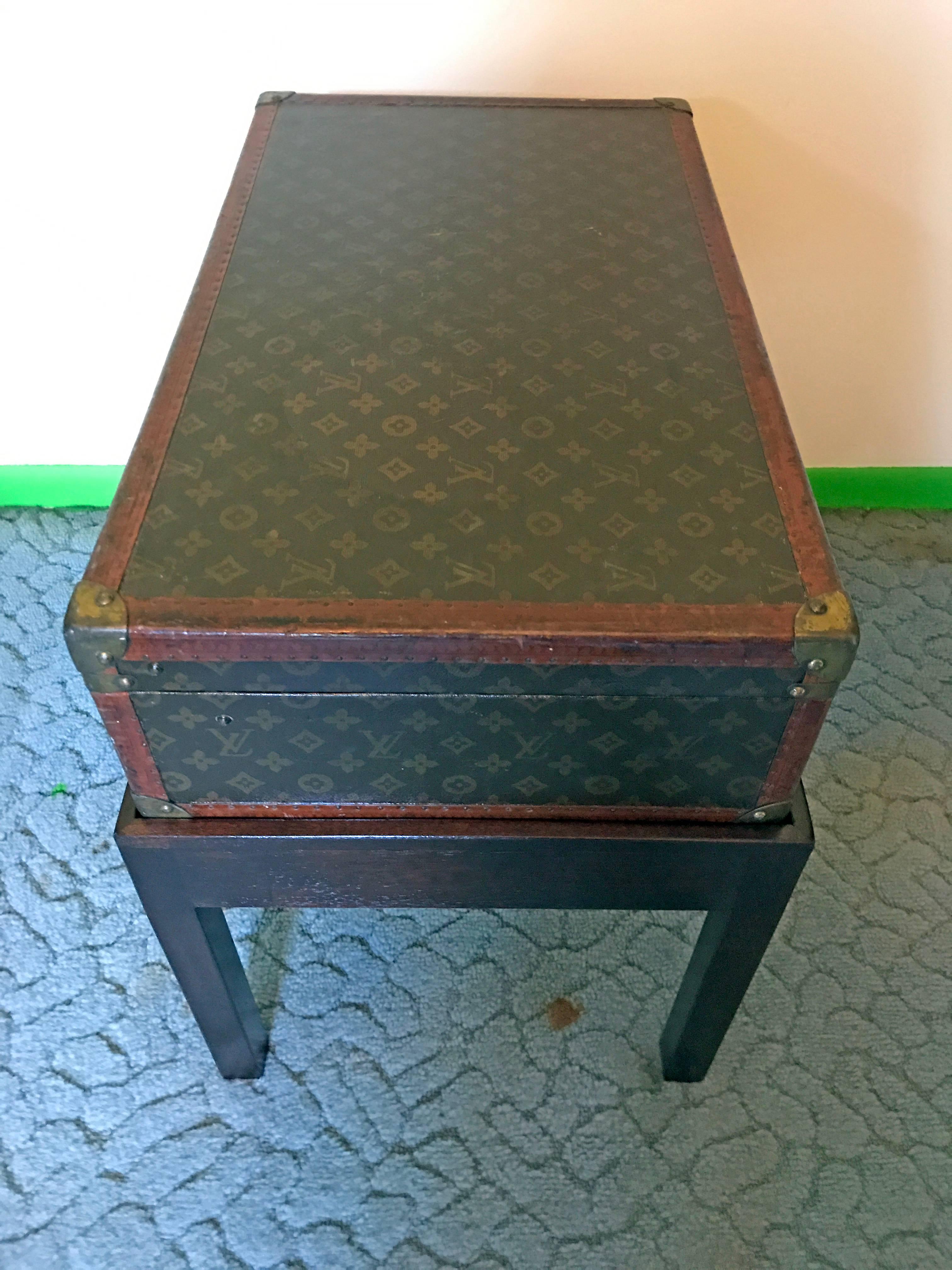 Louis Vuitton steamer trunk on stand, nice intermediate sized vintage Louis Vuitton case on a custom mahogany stand.
Measures: Trunk 25.75 W x 15.25 D x 7 in H
Base 27 in W x 16.5 in D x 15.5 in H
Trunk and base 22.5 in H.