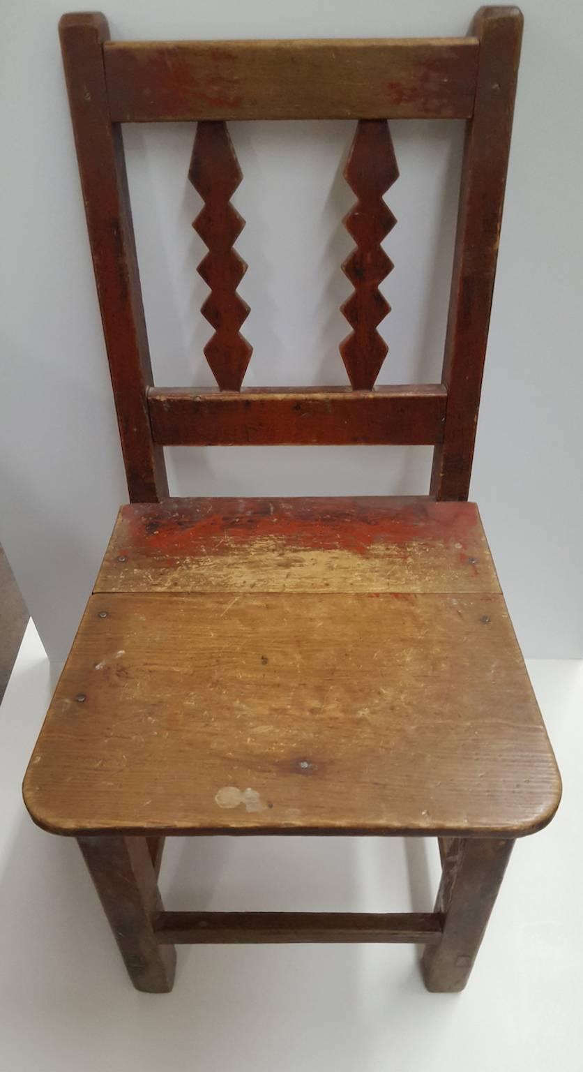 This is an unmatched pair of small, naive, Spanish flavored chairs. They could be used for seating, but may easily be considered folk objects to enjoy visually. Probably constructed in Mexico or New Mexico by local craftsman,
the chairs have a