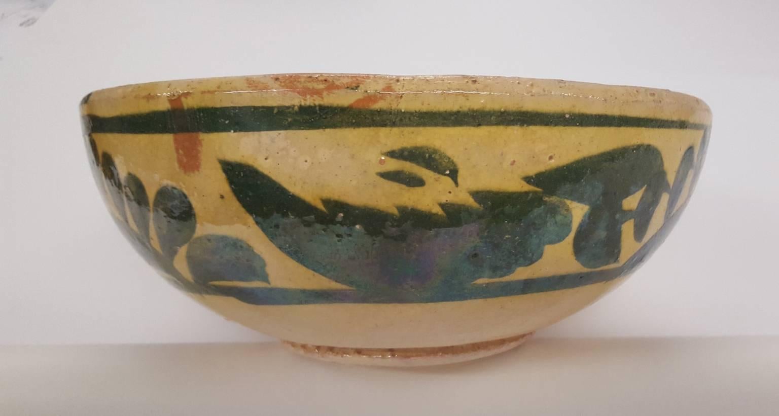 Two small, vintage, Mexican pottery bowls, with same colors (yellow and green) but with different decorative patterns around the exterior. Likely produced in the 1930s or 1940s, these bowls are charming in appearance and most likely to be used as