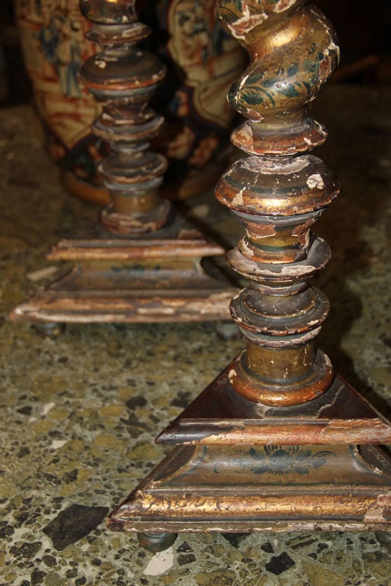 A rare pair of important 17th century Italian polychrome and parcel-gilt barley sugar twist baroque candlesticks, each in untouched, original condition, exhibiting exquisite patina and wear and with no restorations, both with inverted dish bobeches