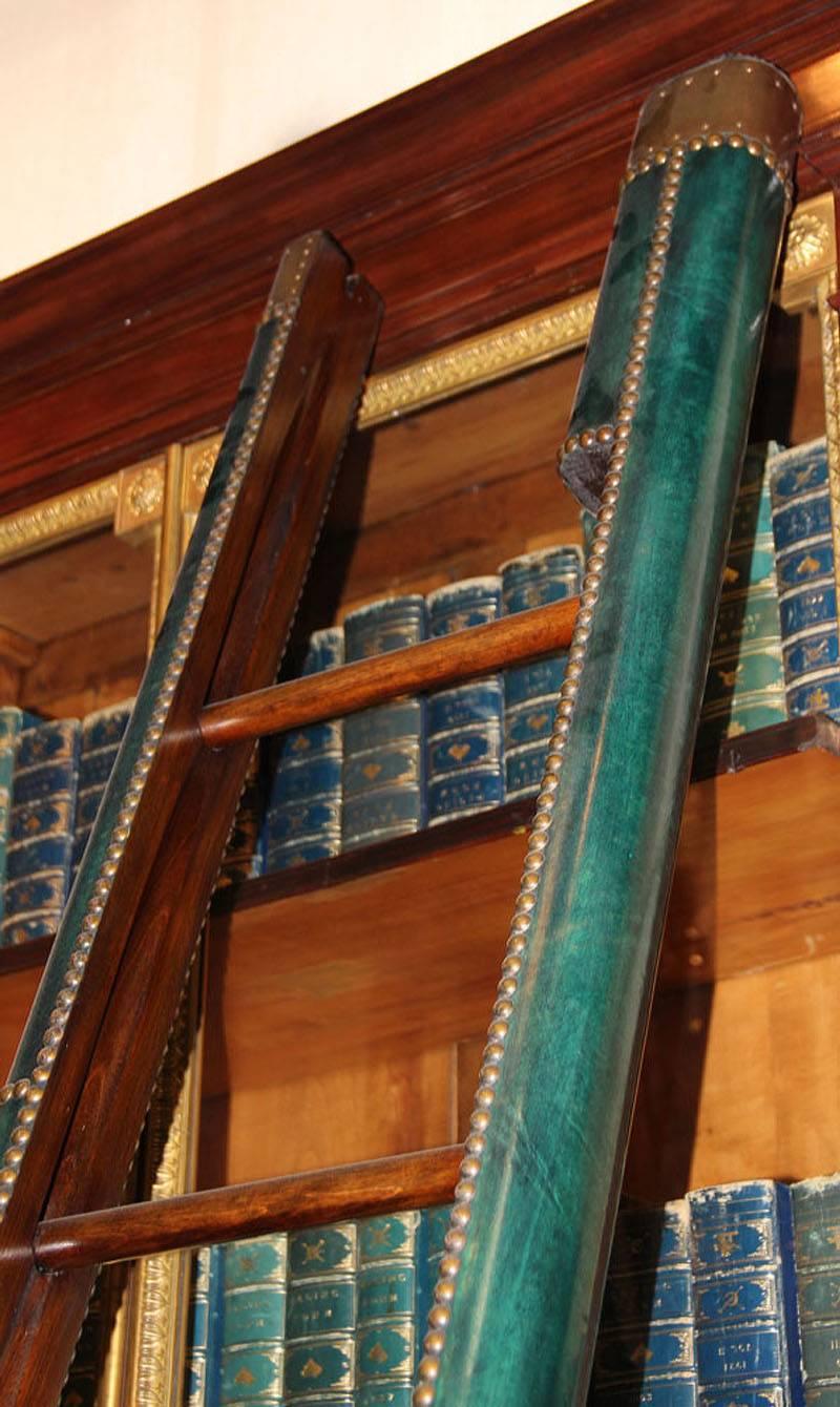 A C. Mariani custom mahogany folding library ladder in the English taste, with forest green leather sides, available in custom colors and with brass nailhead trim, please call for a custom quote.