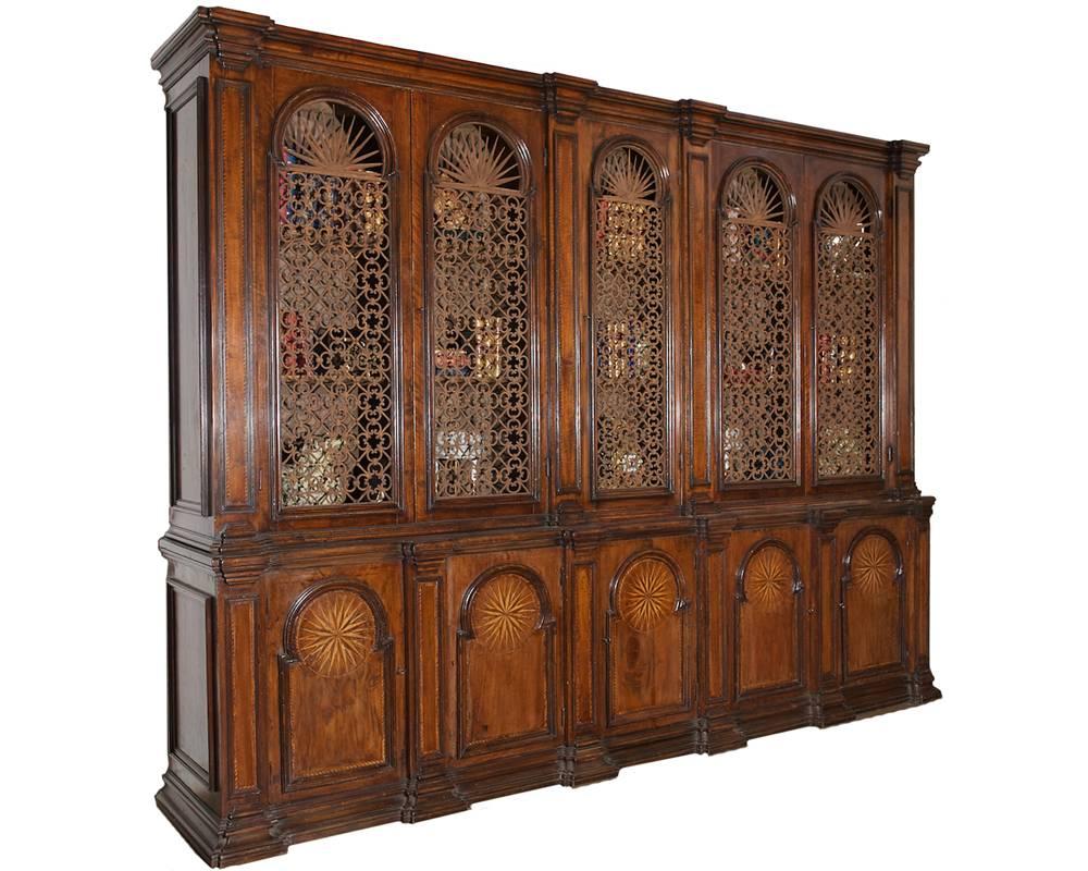 A rare 18th century Tuscan walnut archival, most likely created for the Palazzo Leopoldo, the base composed of five paneled doors centered with baguette molded panels crested with parquetry stellates of alternating exotic woods along with conforming