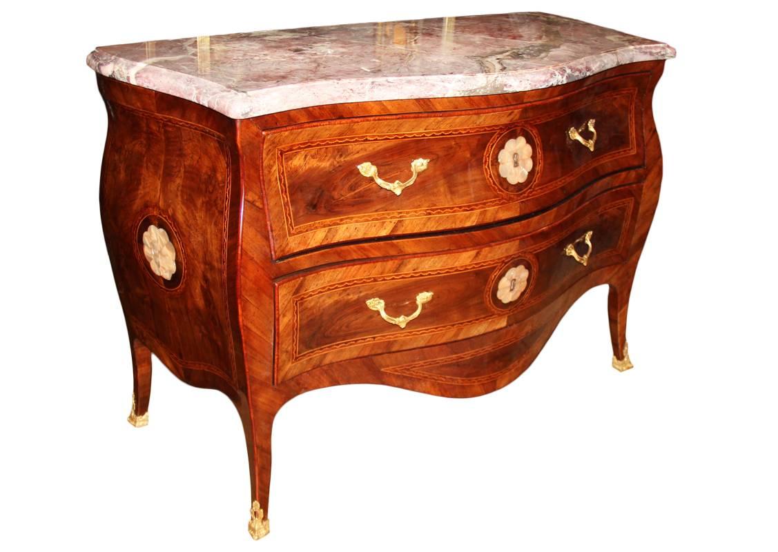 A unique pair of 18th century Neapolitan burl walnut, mother-of-pearl, Parquetry Bombé serpentine commodes, each with a conforming Breccia Fior di Pesco marble top above two long drawers with parquetry banding, each drawer and each side centered by