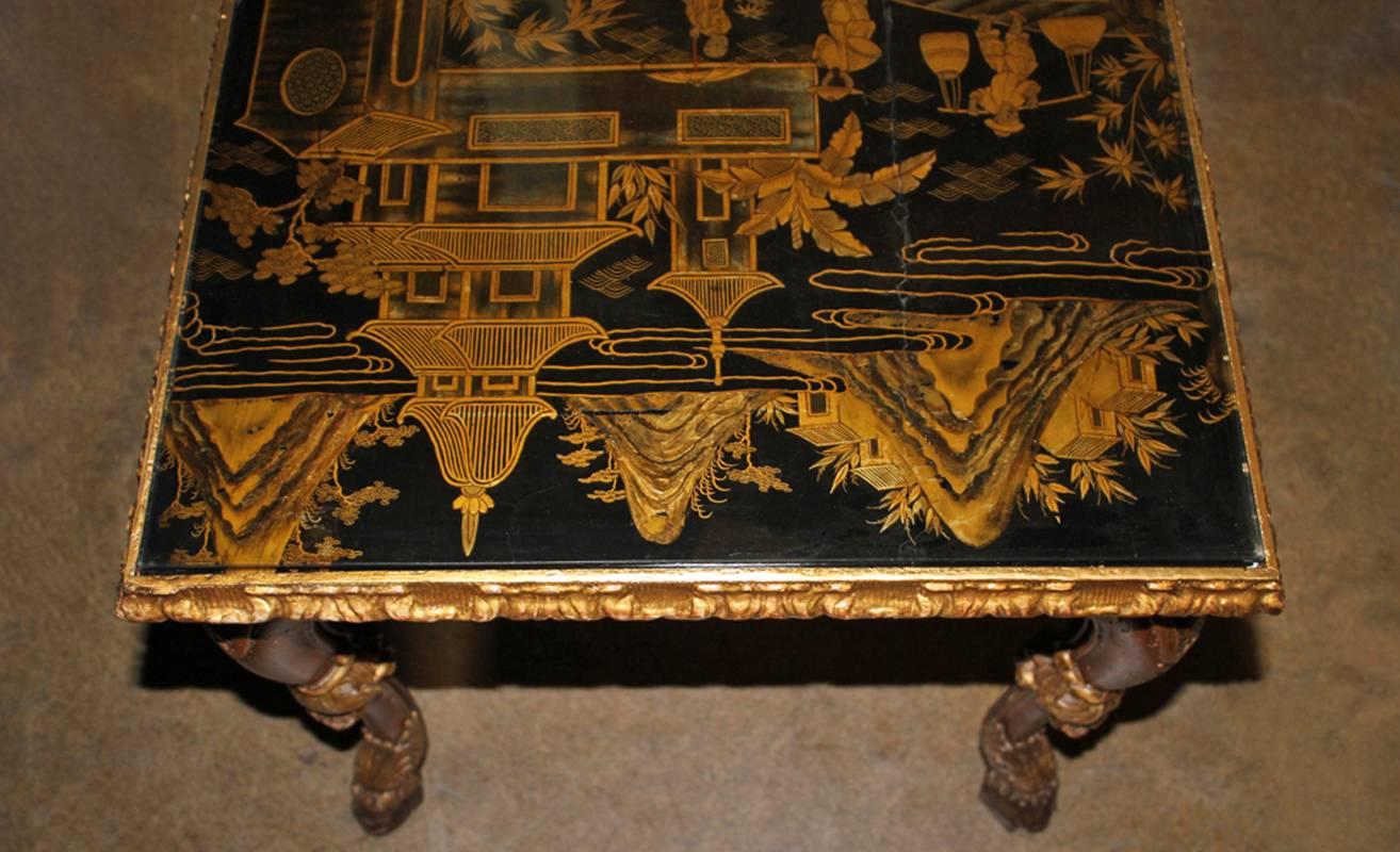 An 18th century Chinese-Export coffee table, the top original 18th century and protected by a glass panel, embellished with lacquered figures and pagodas in a mountainous landscape, above a later Rococo style polychrome and parcel-gilt base with