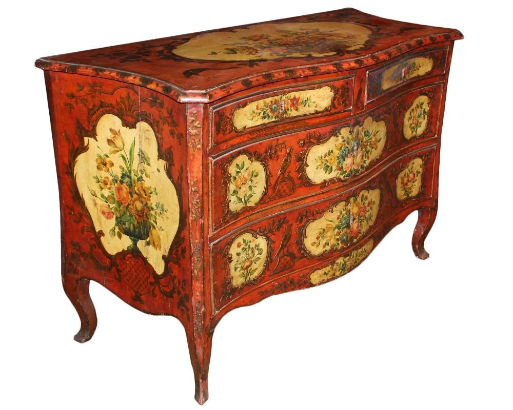 An 18th century Venetian four-drawer polychrome commode, the serpentine top above a conforming base with two short drawers and two wide drawers, each with cartouche panels of flowers, birds, and scrollwork with the whole raised on conforming