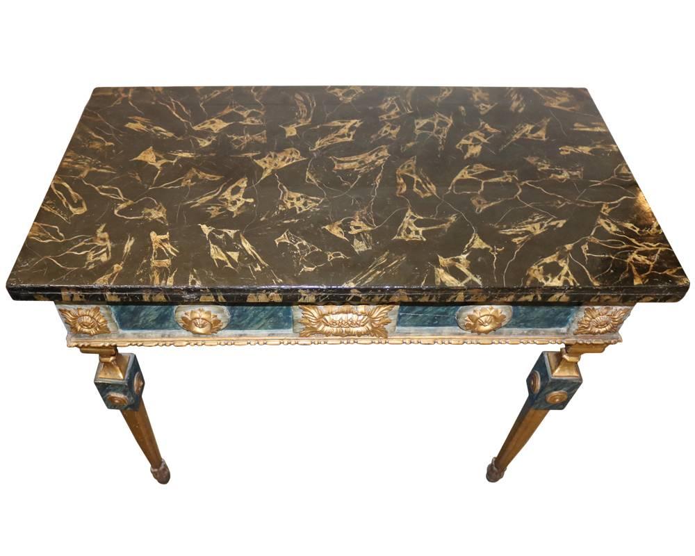 An 18th century, Louis XVI polychrome and parcel-gilt console table, the rectangular faux marble top above a polychrome frieze centered by a sunflower flanked by gilt medallions, on tapered legs with acanthus carved toupie feet.