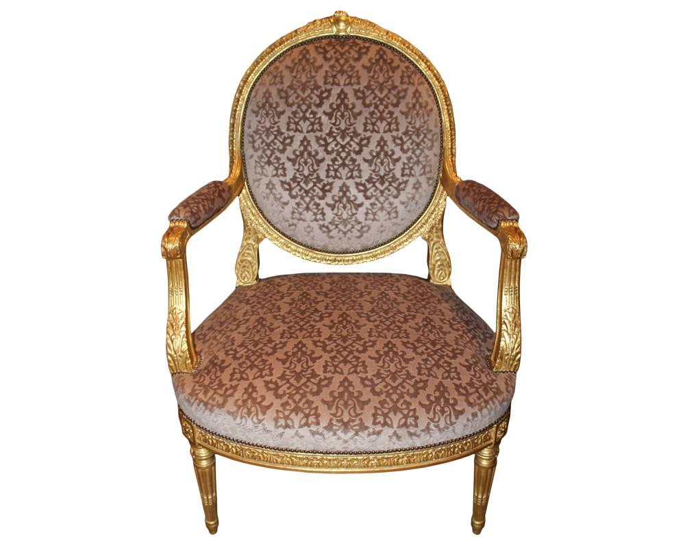 A pair of late 18th century Italian Louis XVI giltwood Marquise armchairs, each chair crested with a cartouche, the whole with carved acanthus and waterleaf giltwood details, and raised on four stop-fluted tapering legs, now upholstered in gauffrage