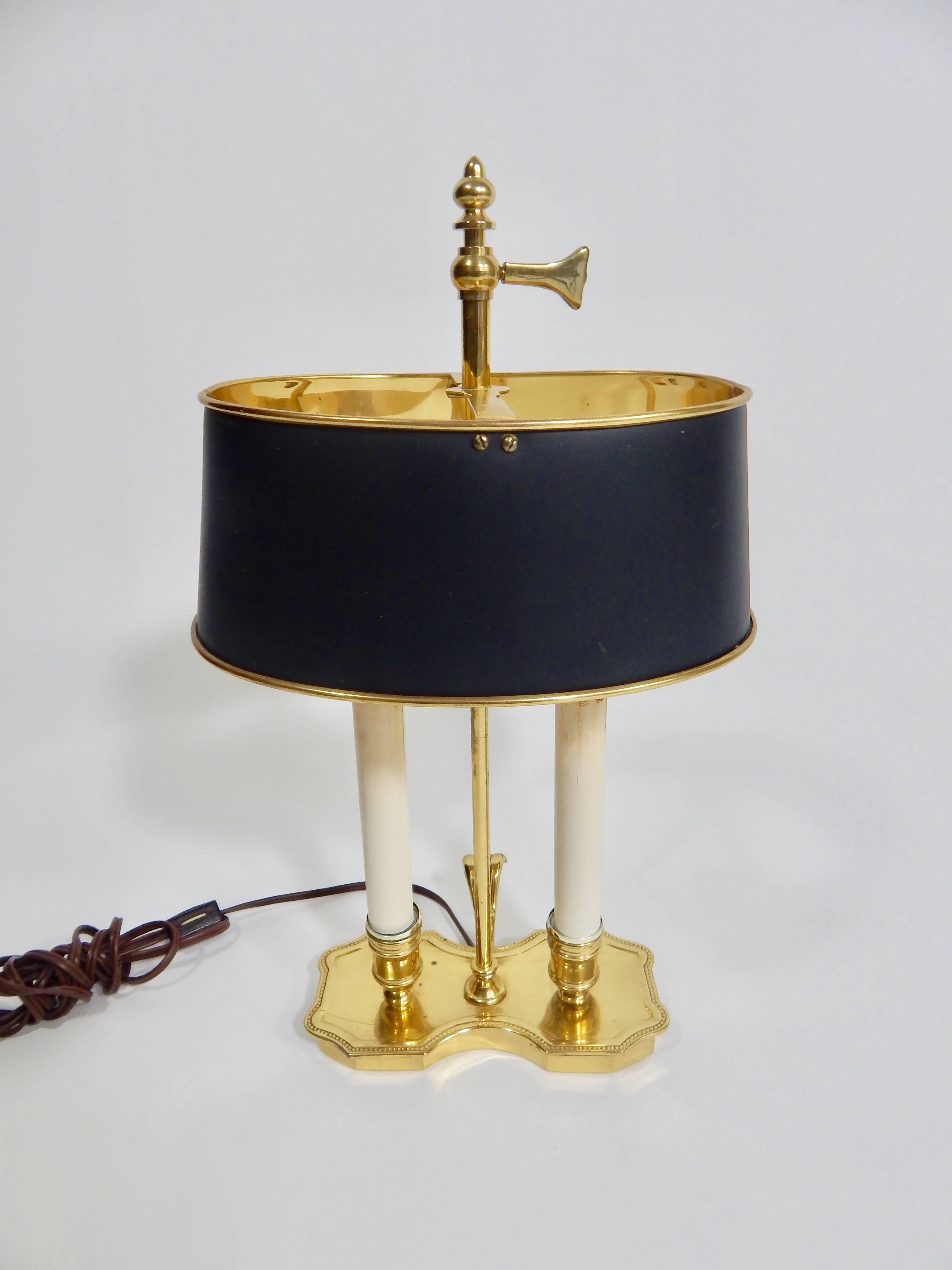 Midcentury, 1960s cute brass French style Bouilette lamp. Black metal shade with gold interior. Exhibits some light wear on the base.