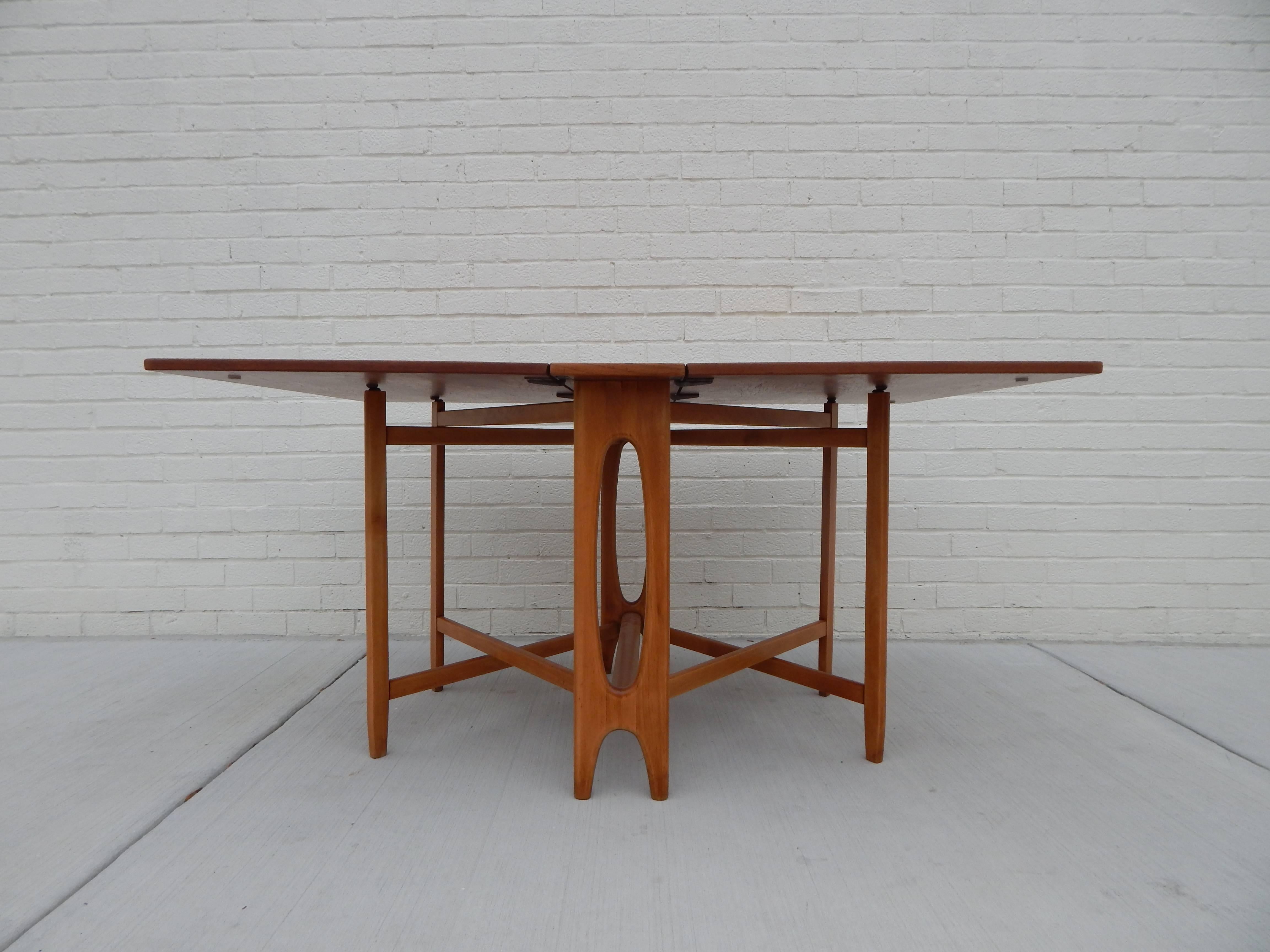 Mid-Century 1960s teak gate leg drop-leaf table. Can fold to be compact or open to seat up to six to be ideal for apartment or small space living. Excellent refinished condition. 
Width closed is 8