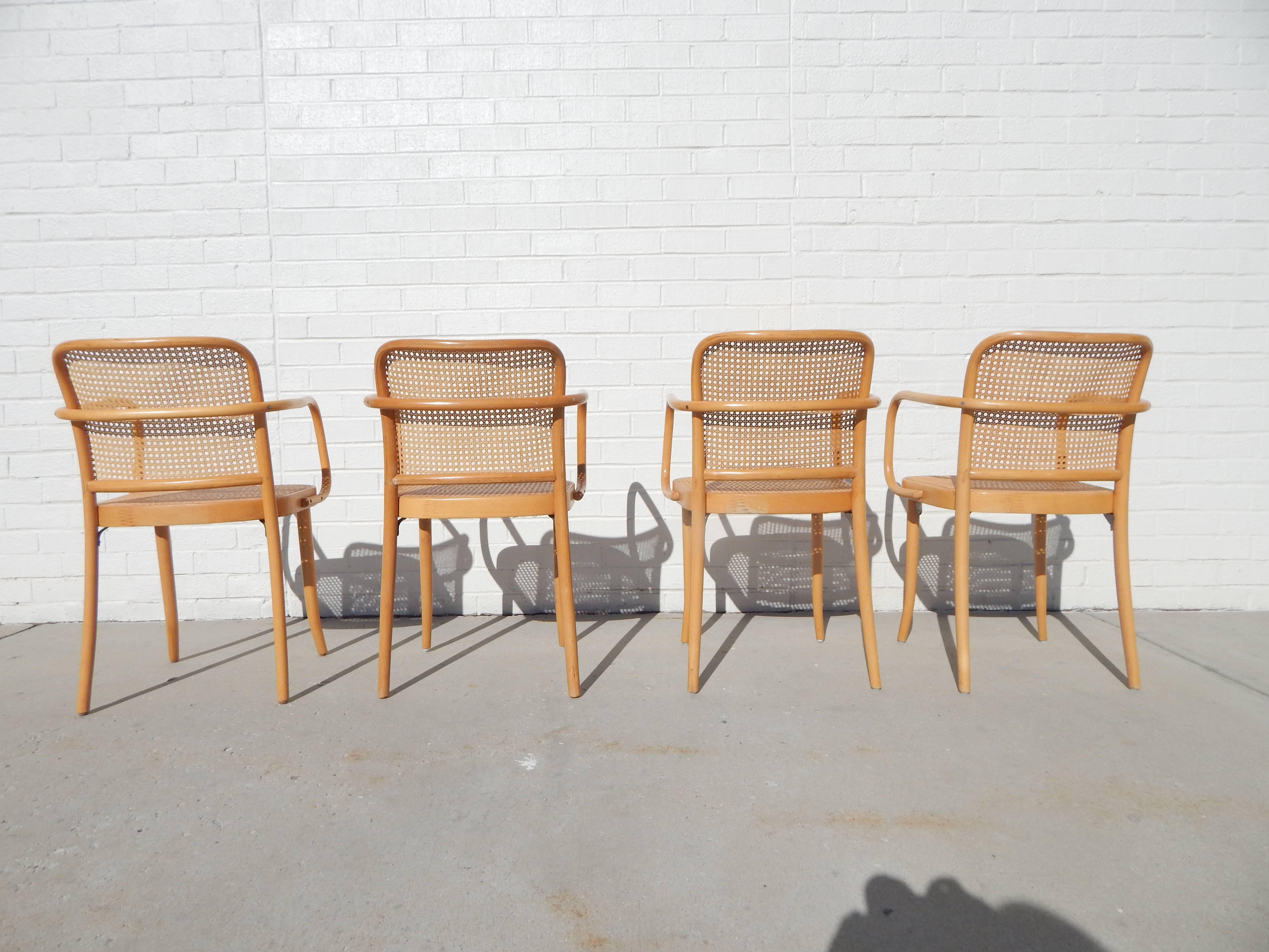 Set of four bentwood and cane armchairs or dining chairs. All caning is in excellent condition. Bentwood frames exhibit minor wear.