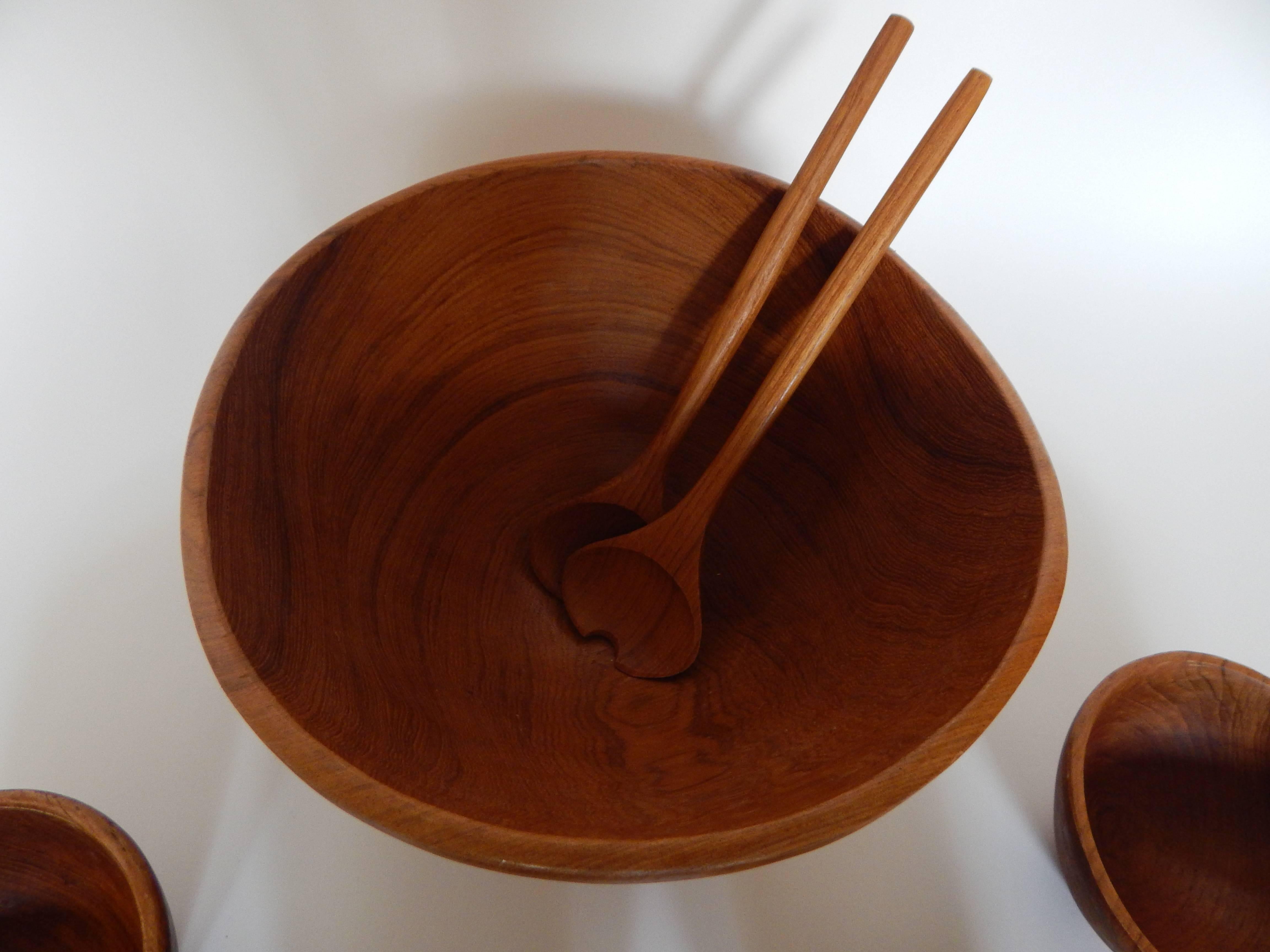 Mid-Century, 1960s hand-turned teak seven-piece salad set. Includes one large bowl, four small bowls and a set of teak salad tossing utinsels. 
All pieces in excellent condition.
