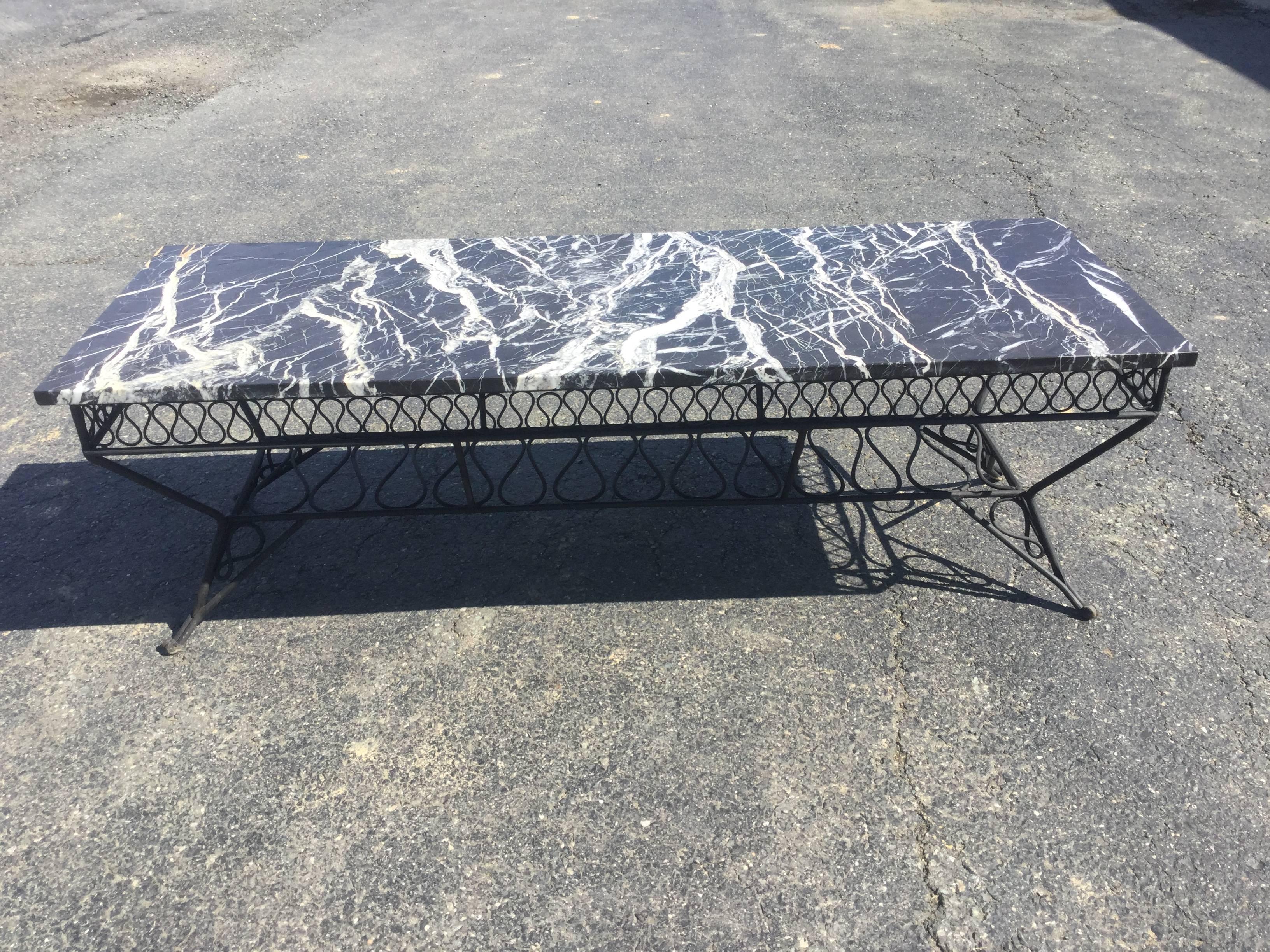 Mid-Century coffee table designed by Maurizio Tempestini for John Salterini. Gorgeous black and white Italian marble on wrought iron base. Ribbon Design. Marble is original and rare to find with original mable intact. 
USA/ ITALY
John Salterini