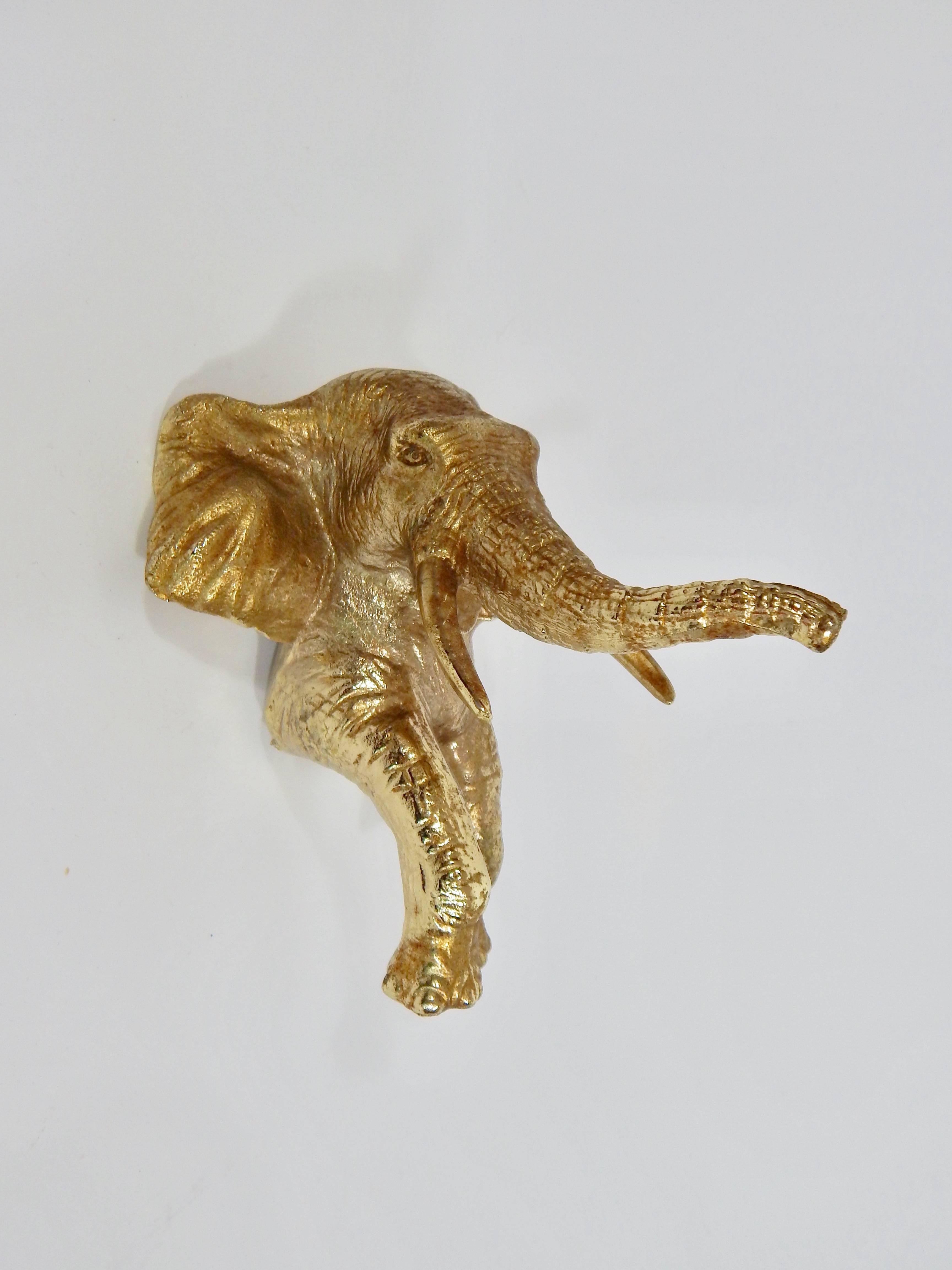 Gold/gilded cast iron wall sculpture/ door mount/handle of the front half of an Elephant. Signed Don Winton Pasadena 1959 the left ear and J. Connor 1959 on the right ear. 

Don Winton was a freelance sculptor from 1952 until his death and