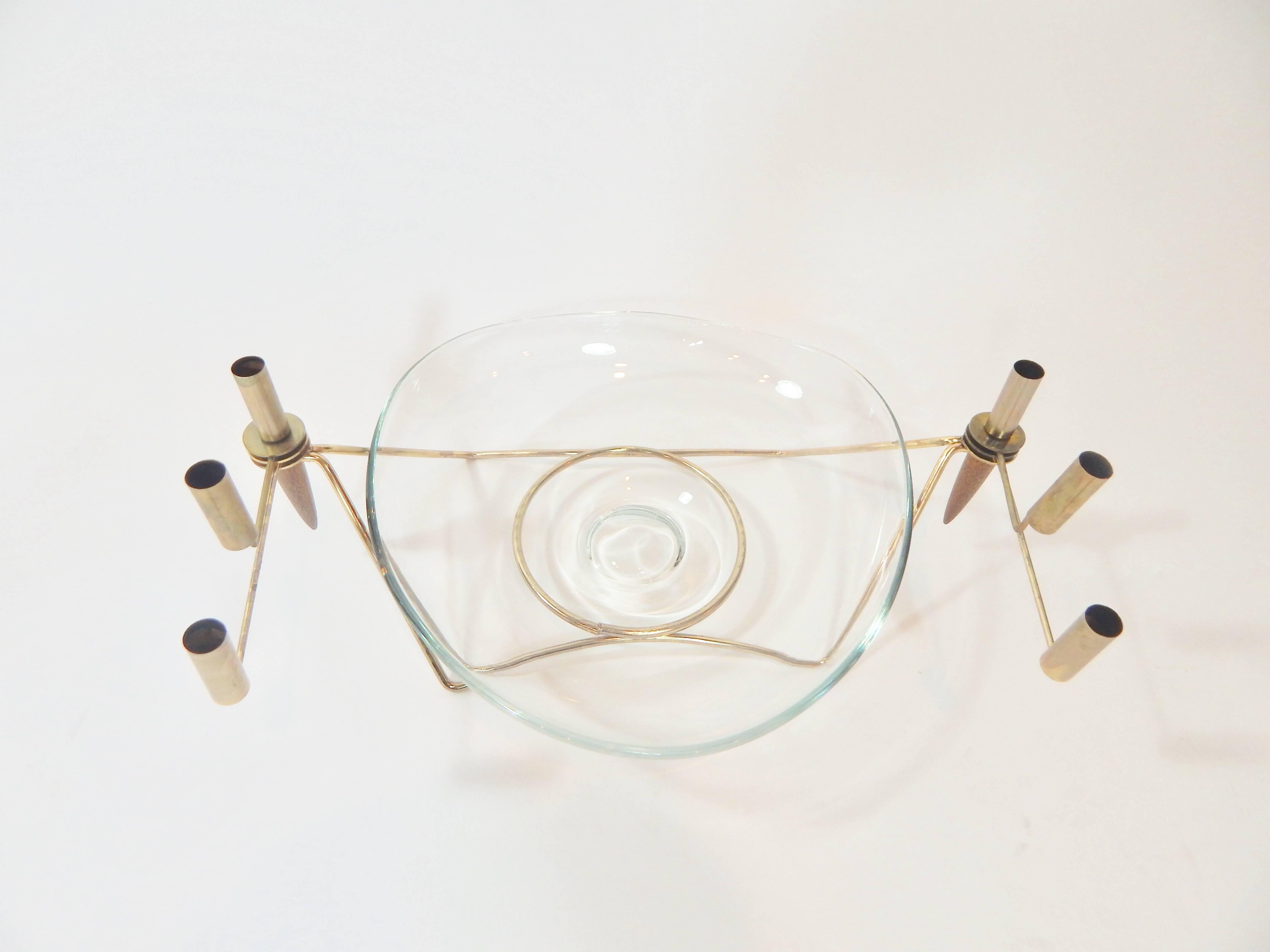 Unique midcentury glass serving bowl or centerpiece. Glass bowl and adjustable gold / brass and walnut candelabra holder. Six candle arms can extend and be adjusted to multiple positions. Glass bowl is removable. 
Measurements: 
Gold holder width 25