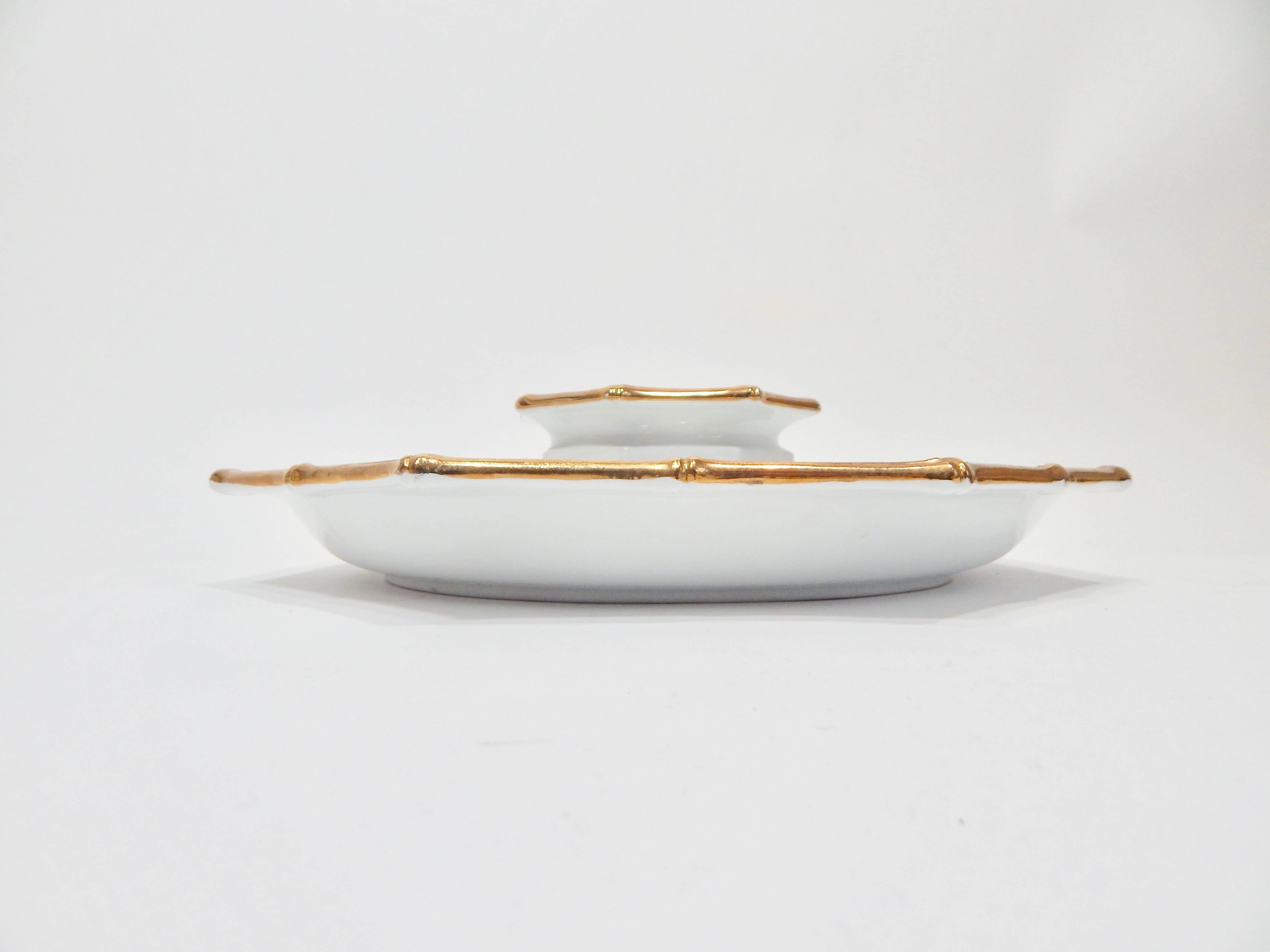 1970s serving plate or platter and bowl designed by Georges Briard. White ceramic with gold gilded faux bamboo trim. Two-piece set. Both pieces are signed. Still retains original stamp. Excellent Condition. US Domestic Shipping is complimentary free