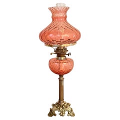 Fine quality antique Edwardian cranberry glass and brass oil lamp