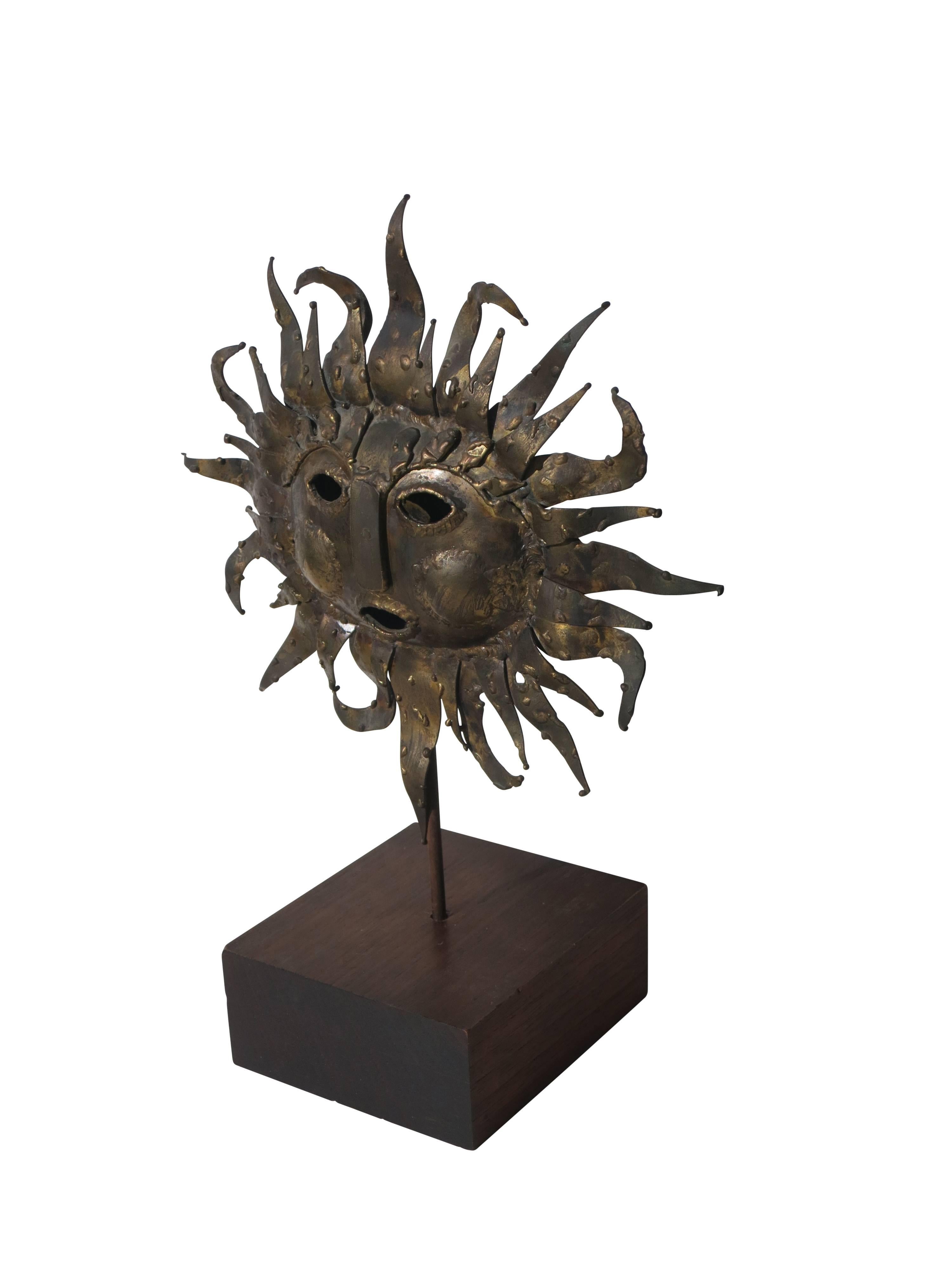 Wonderful table top sculpture of a brass sun mounted on a wooden base.