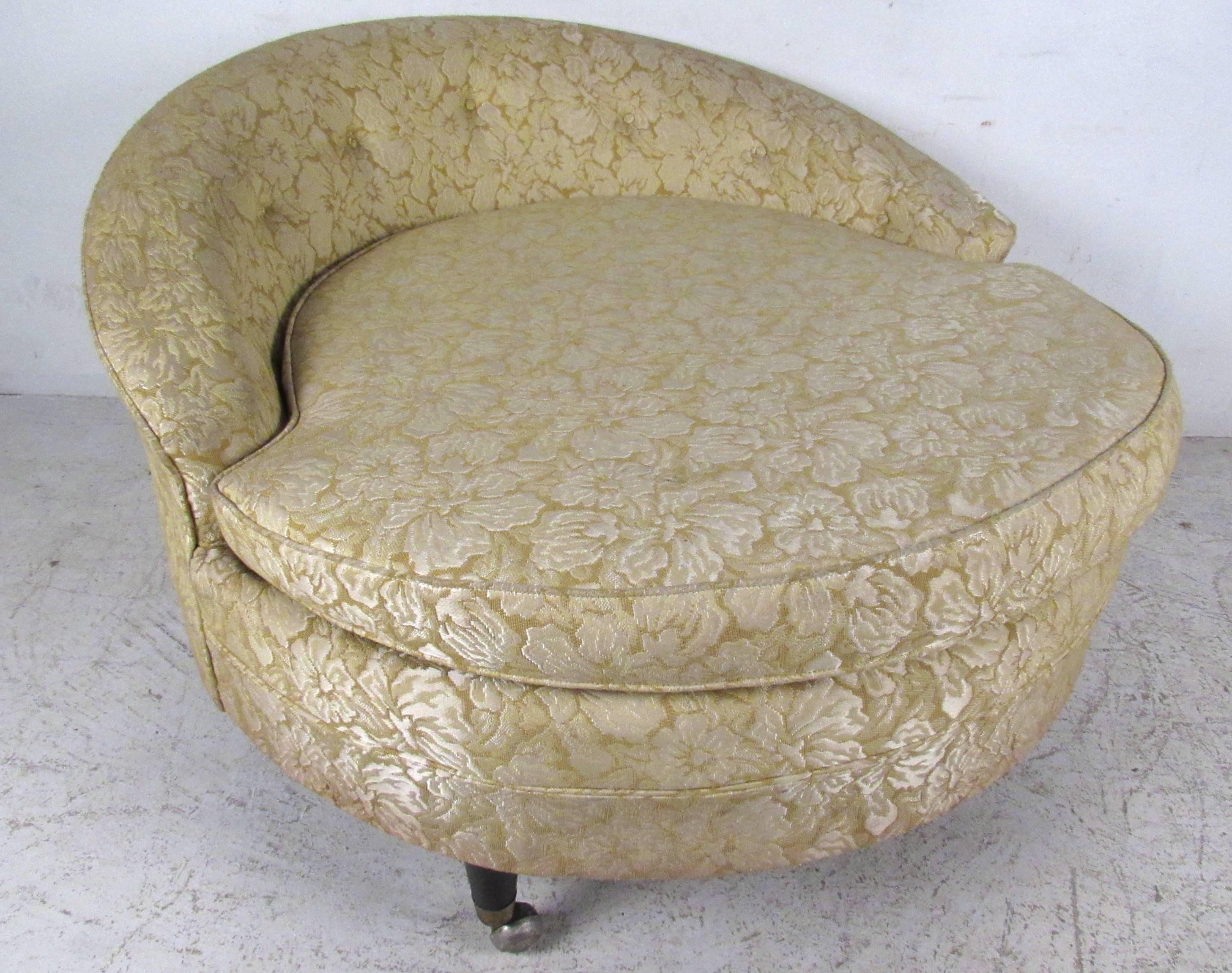 This pair of rolling lounge chairs in the style of Adrian Pearsall make a unique and eye-catching seating addition to a variety of interiors. Unique sculpted backs, tufted fabric, and casters for easy arrangement add to the charm of the pair. Please