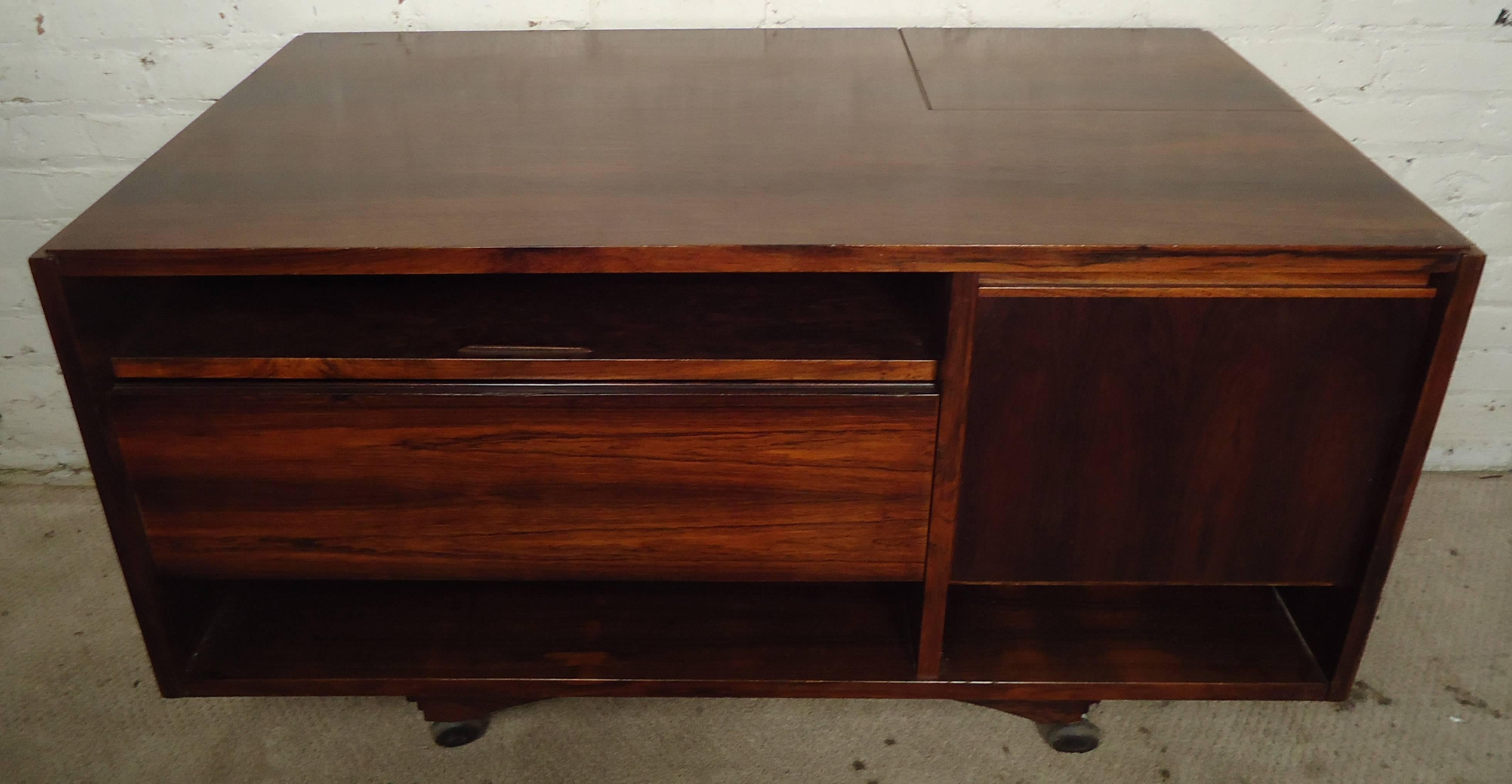 Vintage-modern rolling cabinet, featuring unique storage design and beautiful rosewood grain throughout.

Please confirm item location NY or NJ with dealer.
