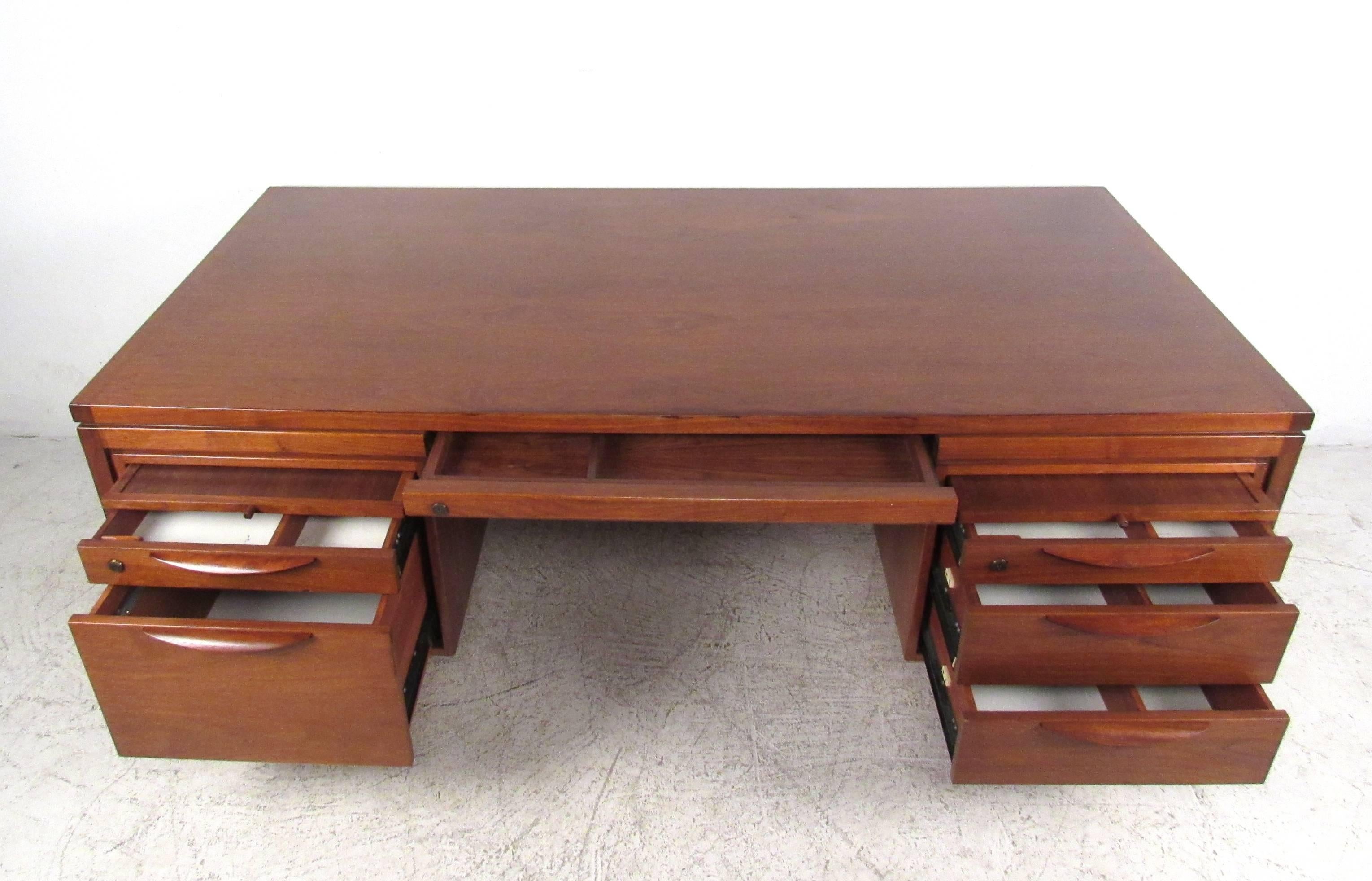 This stunning Mid-Century desk features the quality vintage construction Jens Risom is so well-known for, while offering plenty of organizational and storage options. Carved drawer pulls, extra pull-out work space and it's unique lines make this the