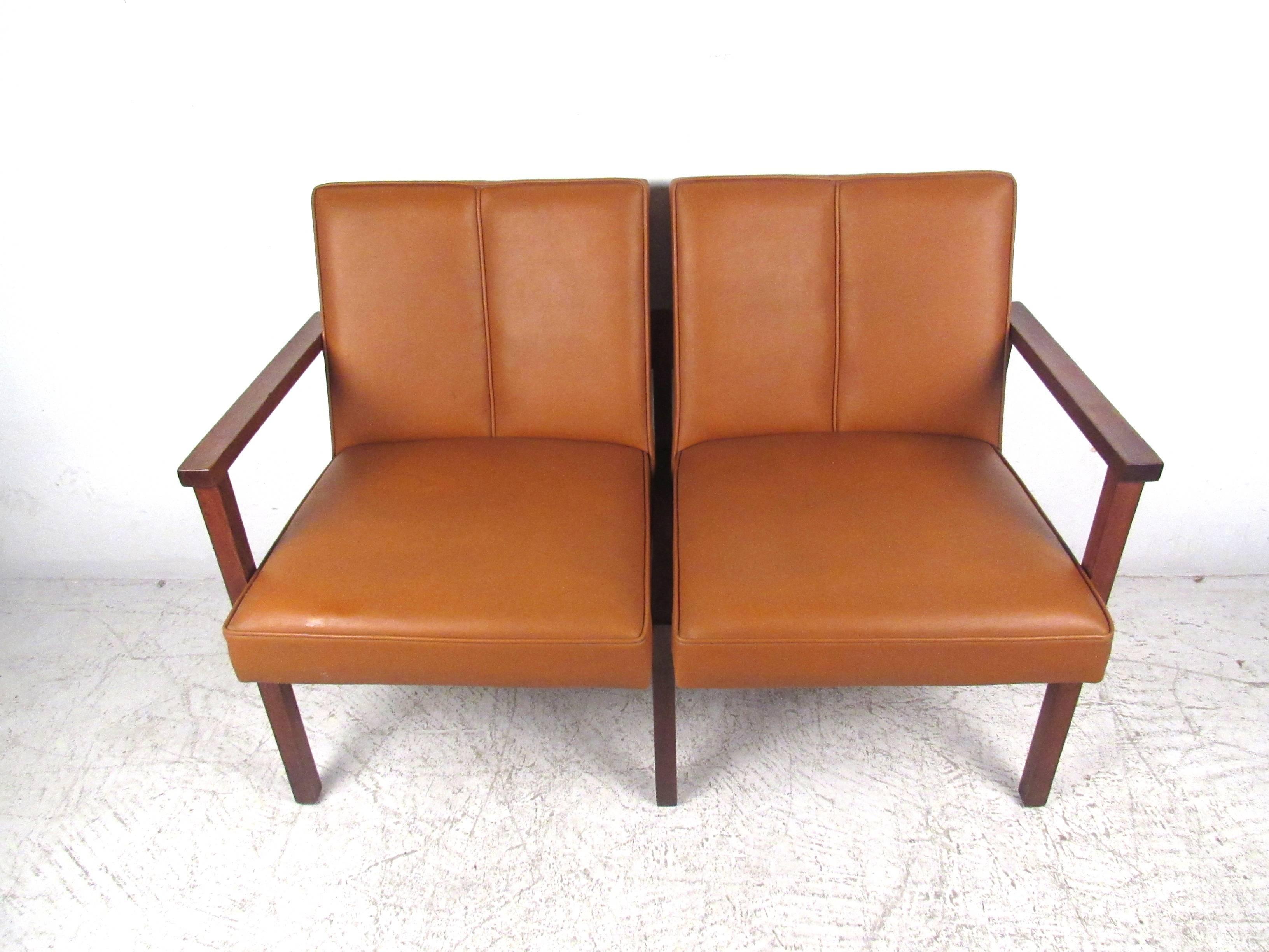 This elegant vinyl and walnut settee features quality craftsmanship, featuring sculpted back and a sturdy frame. The unique appearance and comfort of this piece makes it a wonderful addition to any setting. Please confirm location (NY or NJ).