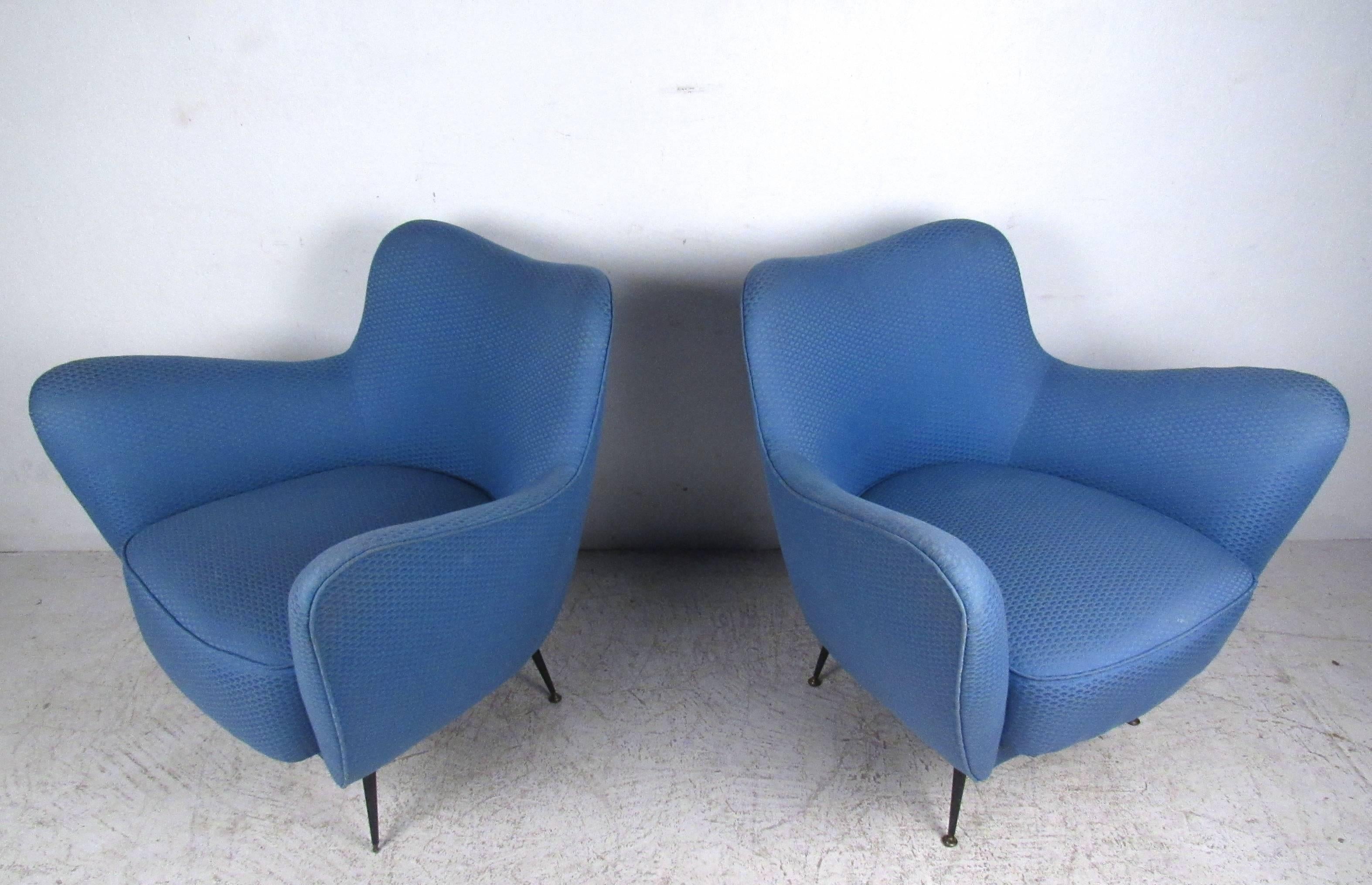 This vintage pair of lounge chairs features spacious seats, unique upholstered sculptural frames, and tapered metal legs. Vintage fabric boasts a subtle pattern, and makes these a great choice for a variety of interiors. Matching loveseat also