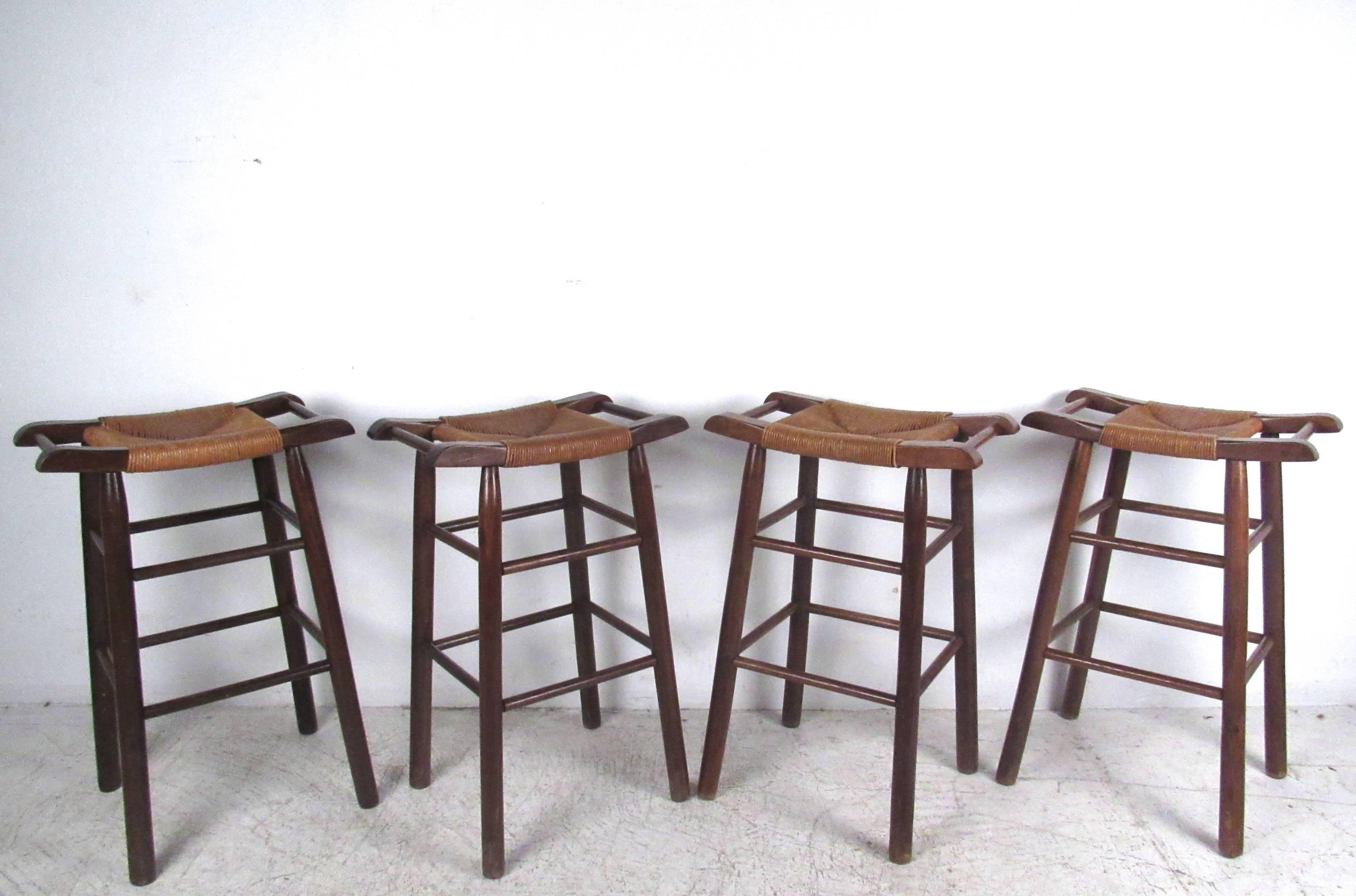 This set of hardwood stools features wide rush seats with unique side handles. Vintage rustic style for bar or counter seating in any setting. Please confirm item location (NY or NJ).