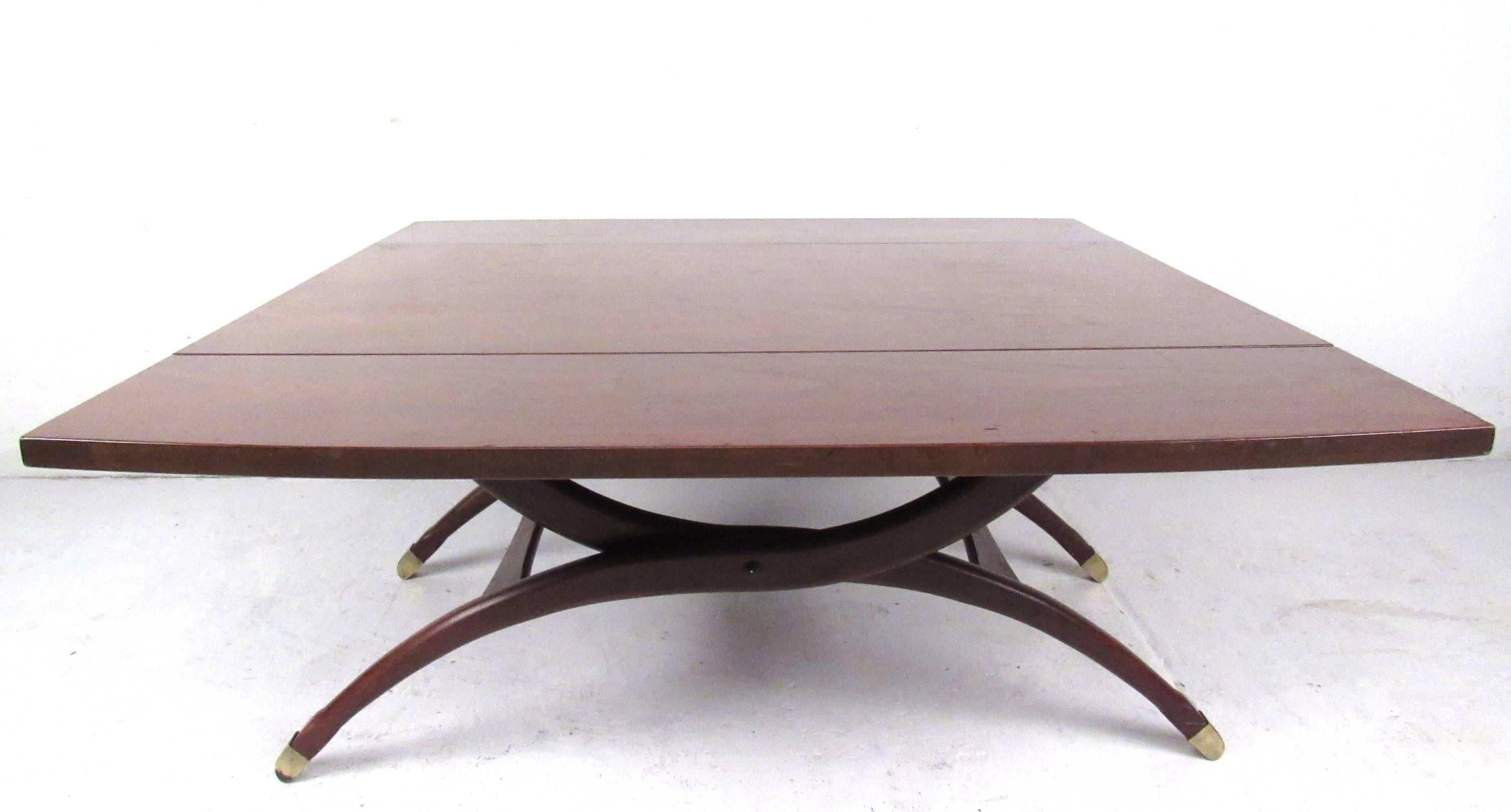 This unique vintage drop-leaf table features a well crafted spring action elevator function, switching from coffee table to dining table height. The versatility and style of the piece includes Dual drop leaves (opens to 39w), tapered/curved legs and