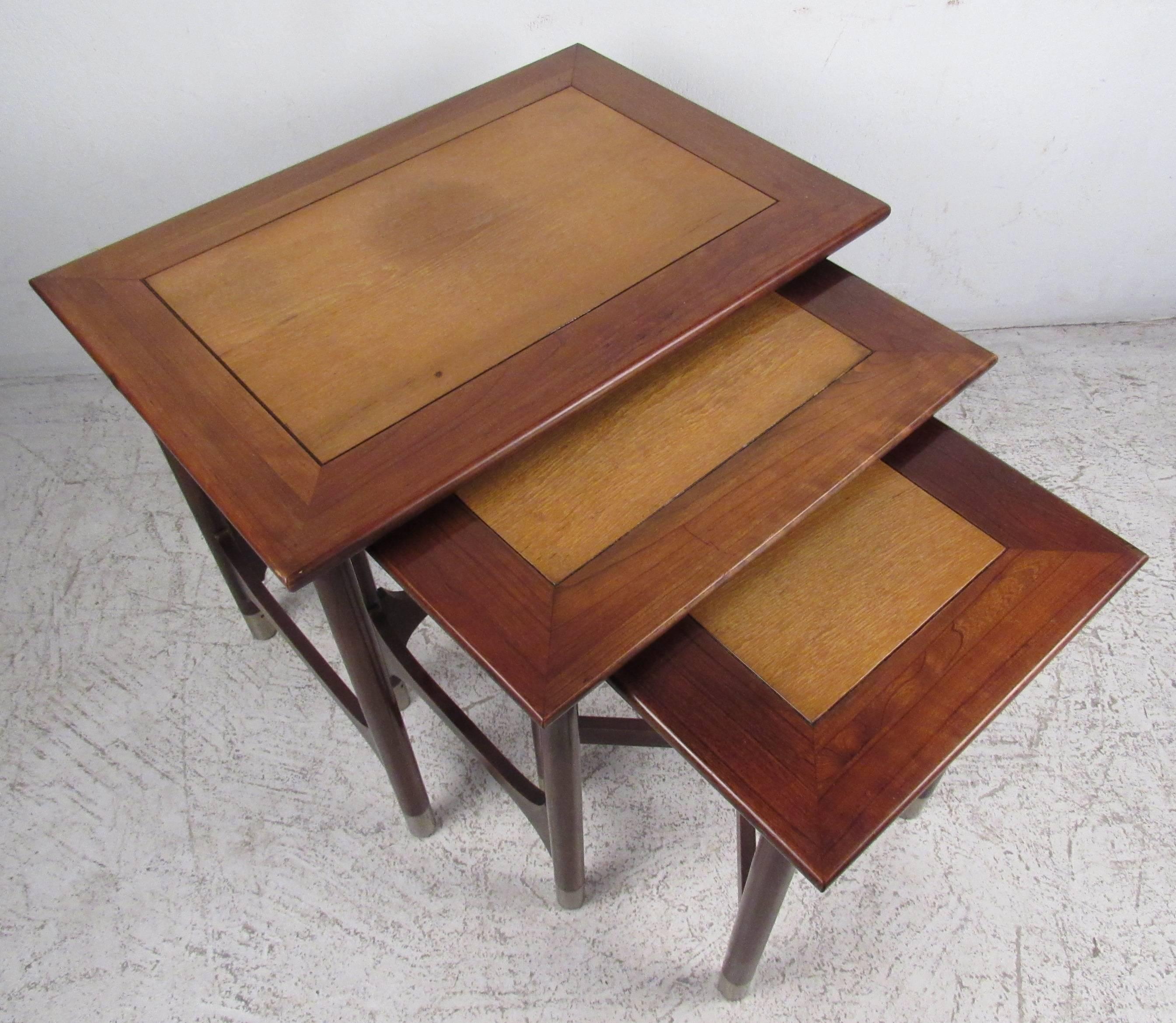 Three vintage-modern nesting tables featuring beautiful wood grain and sculpted legs with chrome capped feet. Perfect set of tables for any application, designed by Weiman. 

Dimensions:
26 W, 18 D, 22 H.
20 W, 17 D, 21 H.
16 W, 15 D, 20 H.

Please