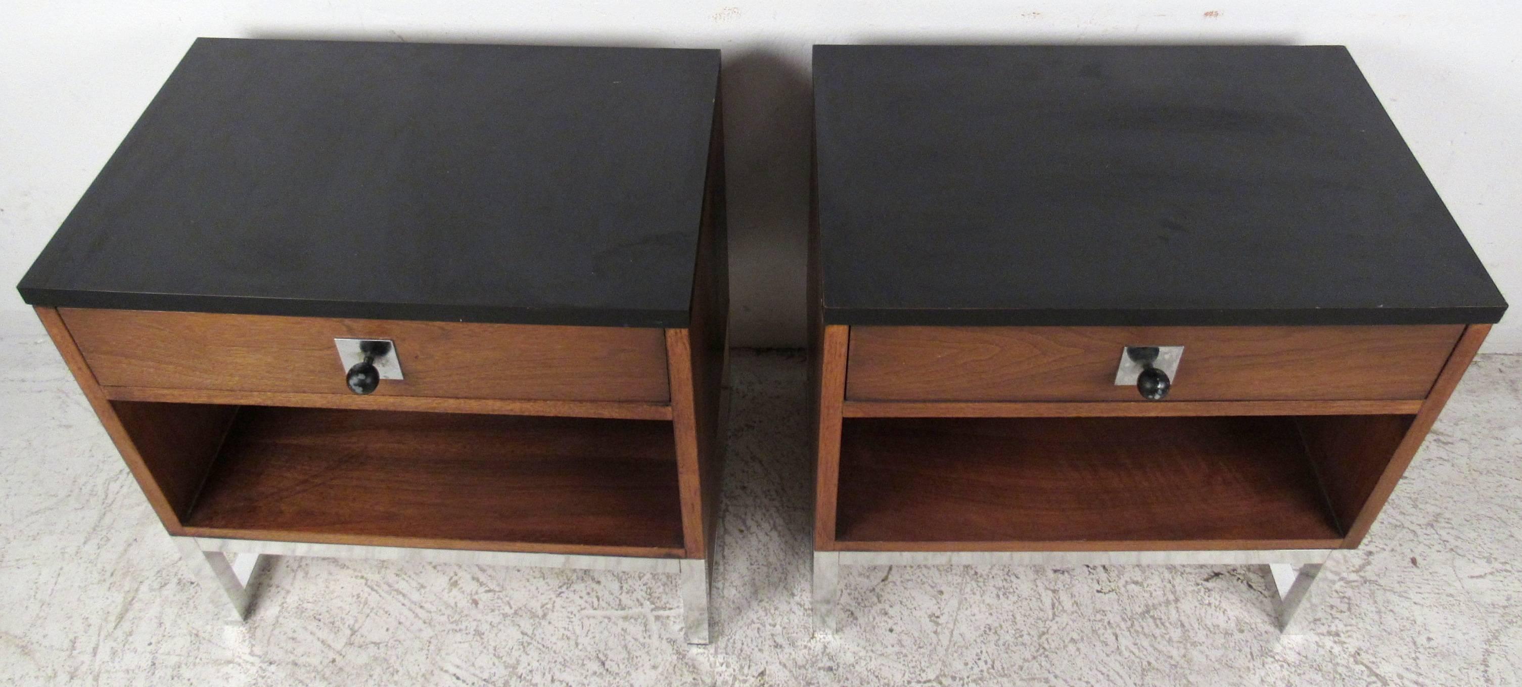 Two vintage-modern nightstands featuring chrome base, rich walnut grain and formica top, designed in the manner of John Stuart. Impressive mid-century design adds both style and storage to home or office. 

Please confirm item location NY or NJ with