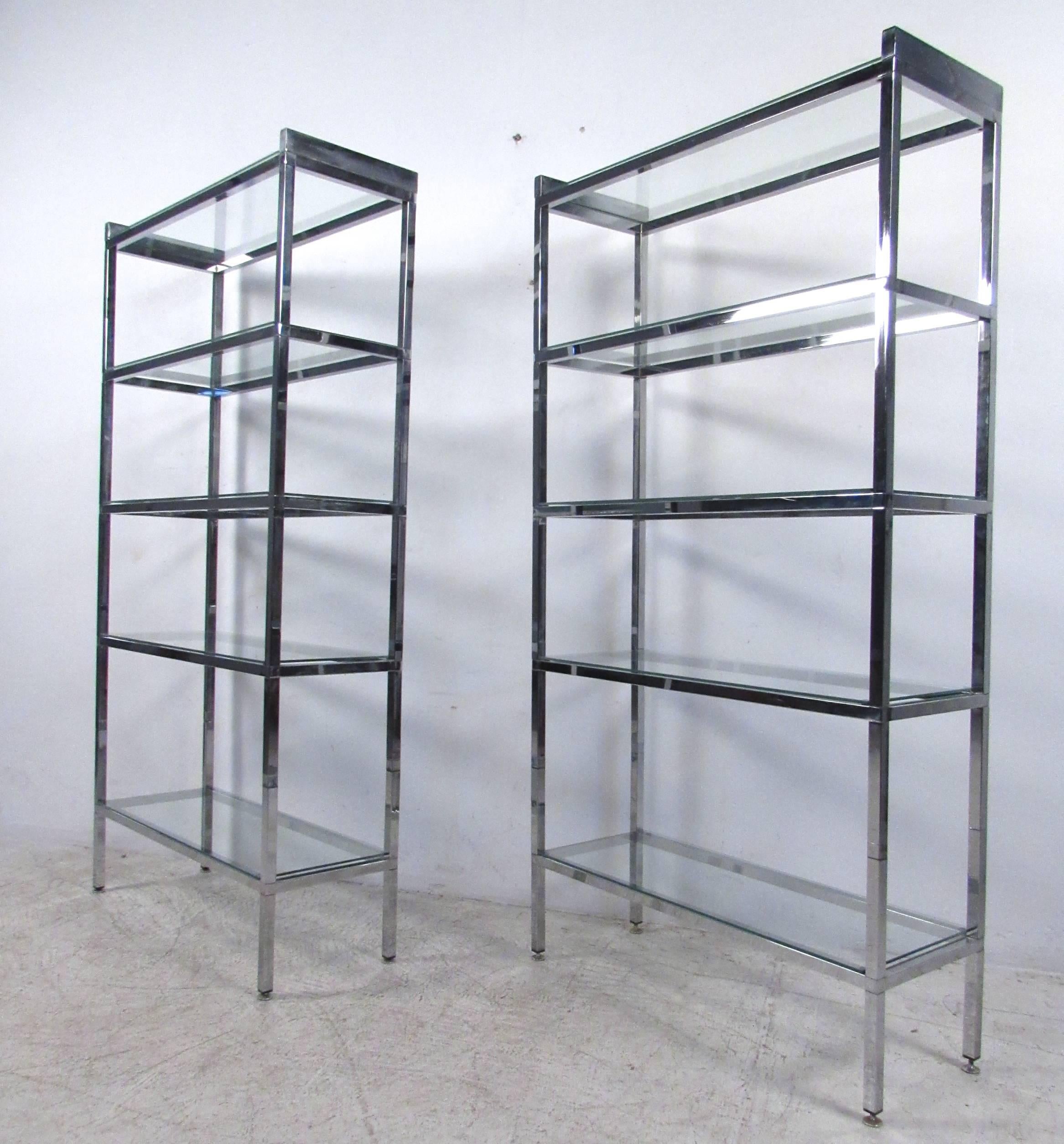 This unique matching pair of vintage chrome and glass ètagerè shelves make the perfect display pieces for home or office. With five shelves a piece, this Mid-Century set of shop displays is great for storage or otherwise, their simple modern style