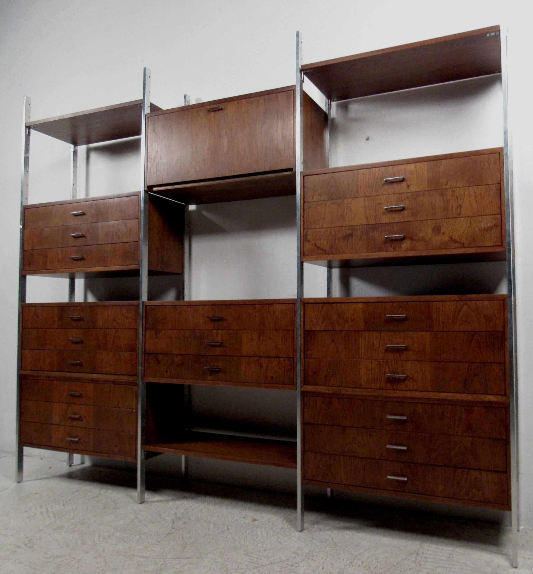 Stylish modular wall unit features vintage-modern design including chrome frame and handles.  Walnut finish and quality mid-century modern construction make this versatile  unit the perfect mix of drawer, cabinet, and shelf storage.
Please confirm
