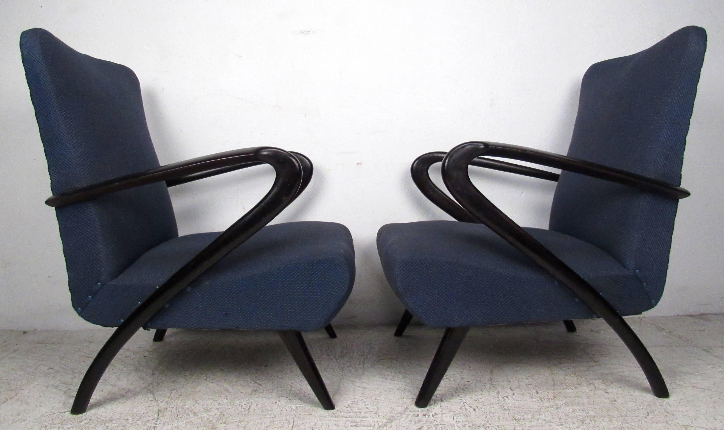 Stylish pair of vintage modern Italian armchairs make an elegant mid-century addition to home or business lounge or salon seating. The sculptural lacquered arms and seat back offer timeless comfort and the iconic style after Paolo Buffa. 
Please