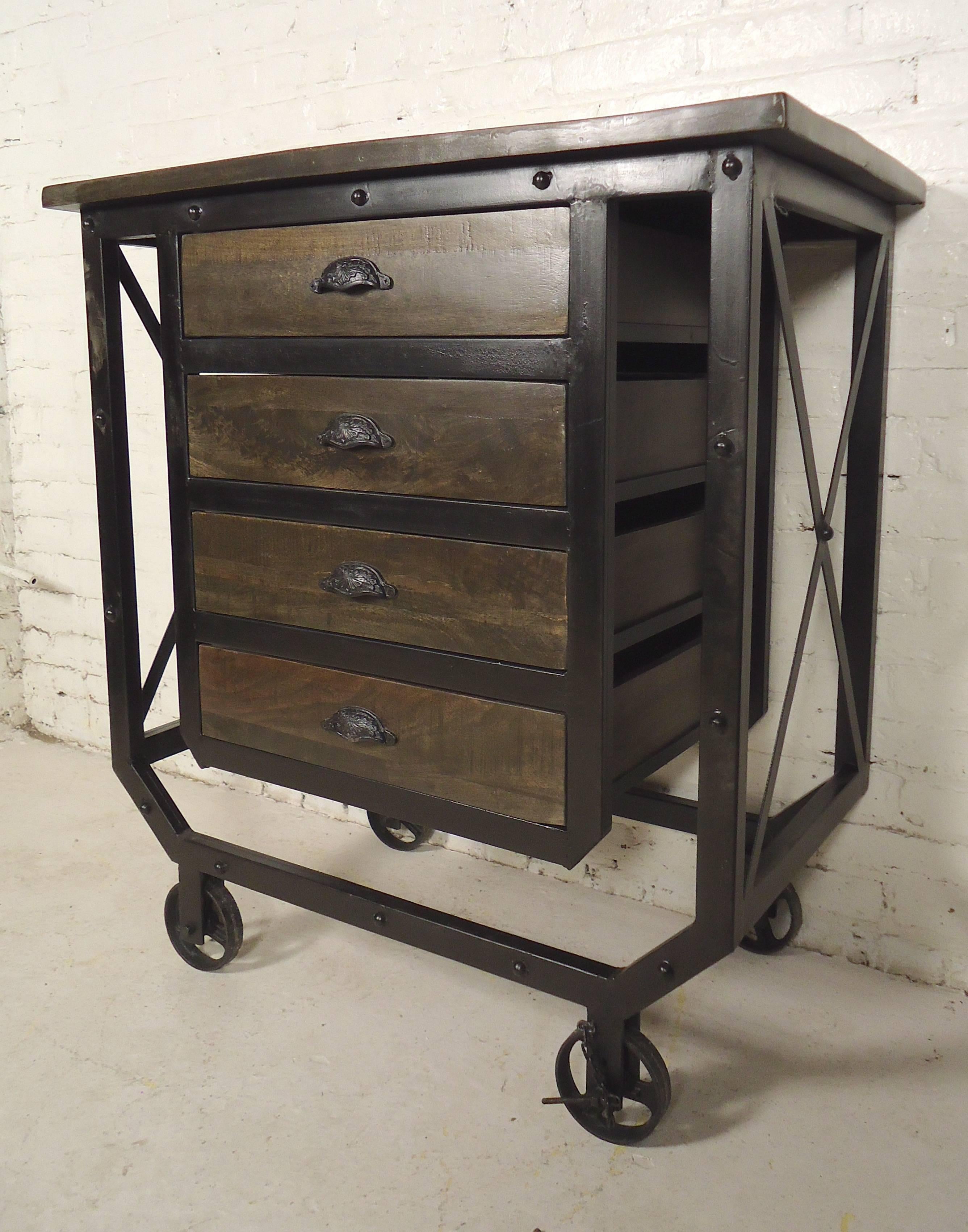 Heavy duty Machine Age style cart with strong reclaimed iron and wood, constructed into this modern rolling storage unit. Black painted metal frame, wood top and drawers, great for living room, kitchen or bathroom use. Wheels can lock.

(Please